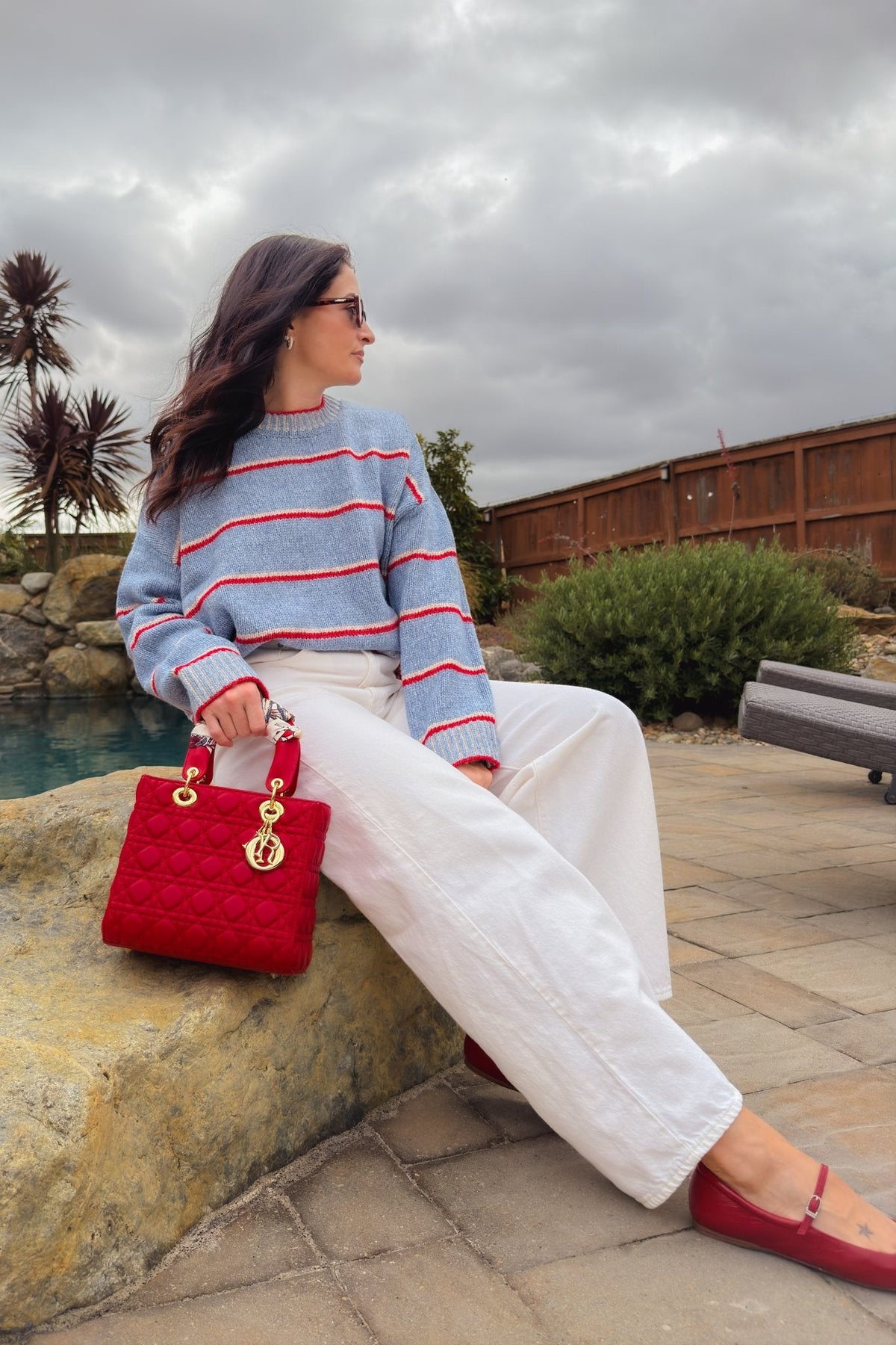Soft light blue sweater with red stripes and relaxed oversized silhouette