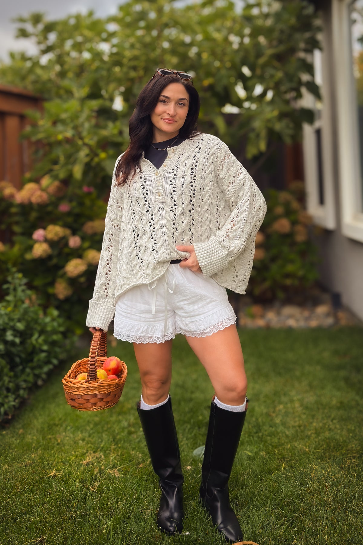 Feminine light gray open knit sweater with Henley buttons, cable texture, and oversized fall styling.