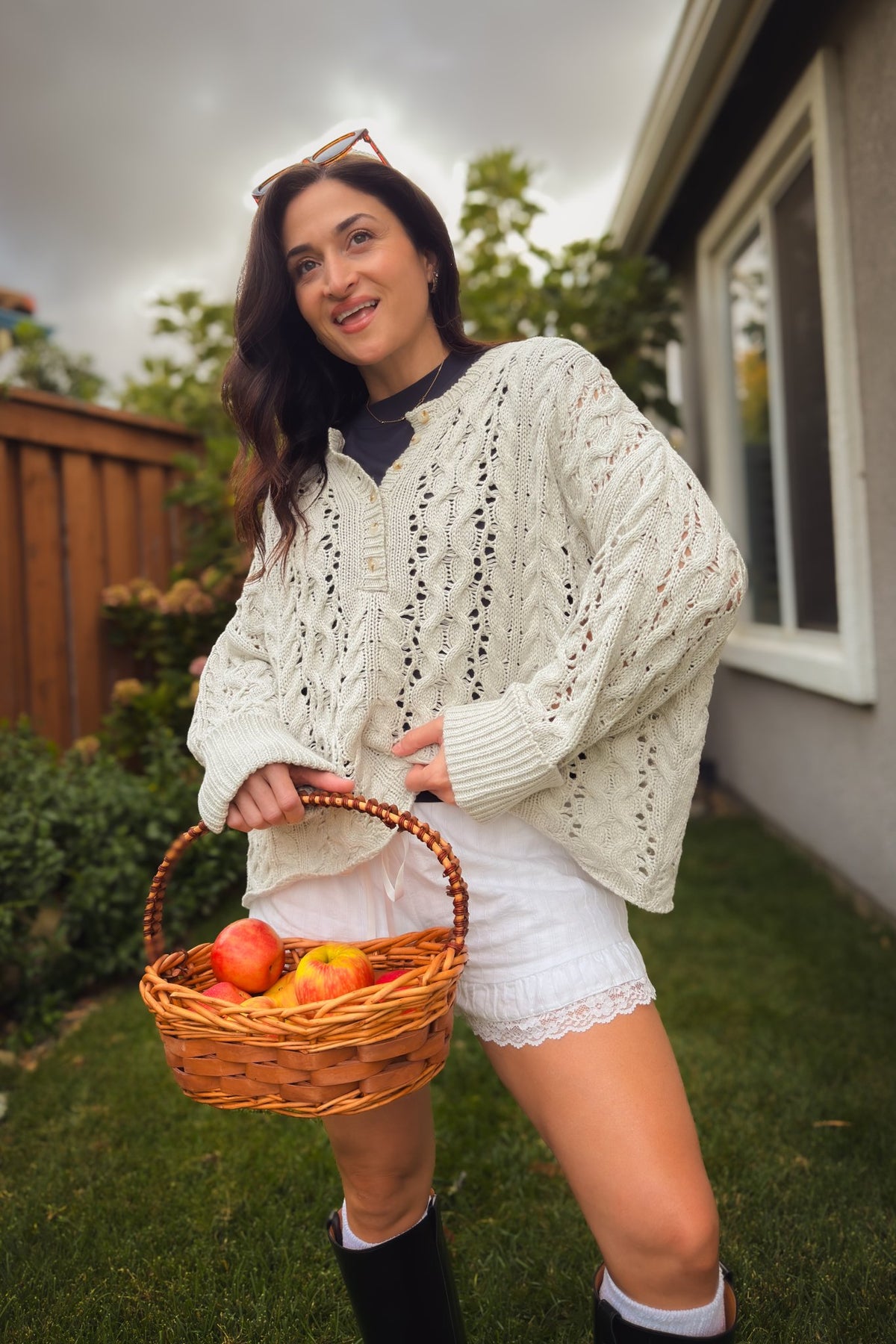 Women’s light gray open knit sweater with button Henley neckline and slouchy drop shoulder fit.