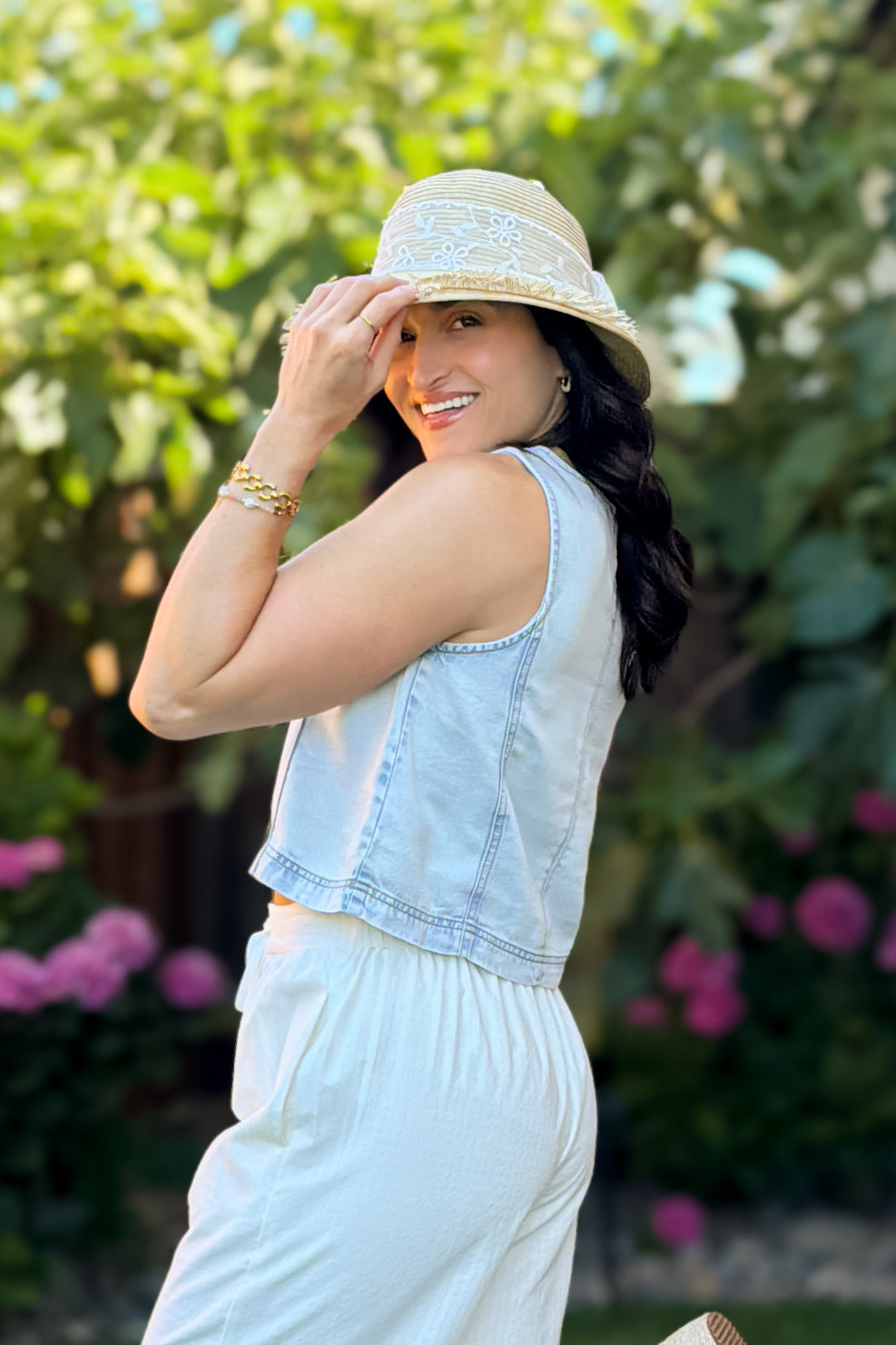 Side view of a light wash lyocell cropped tank top for women featuring a soft lightweight denim look and relaxed fit.
