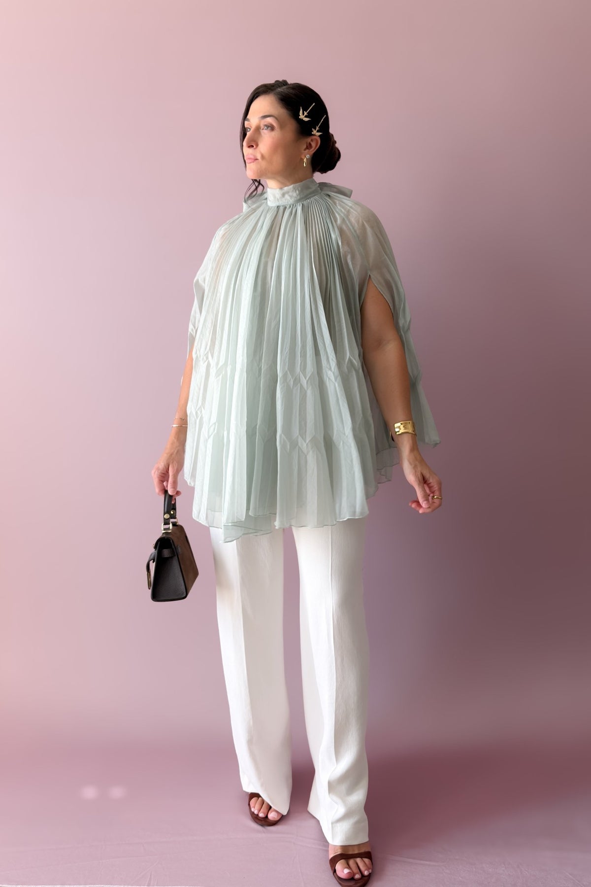 1. Side view of mint pleated maxi skirt showing layered tiers, soft drape and flowing pleated texture