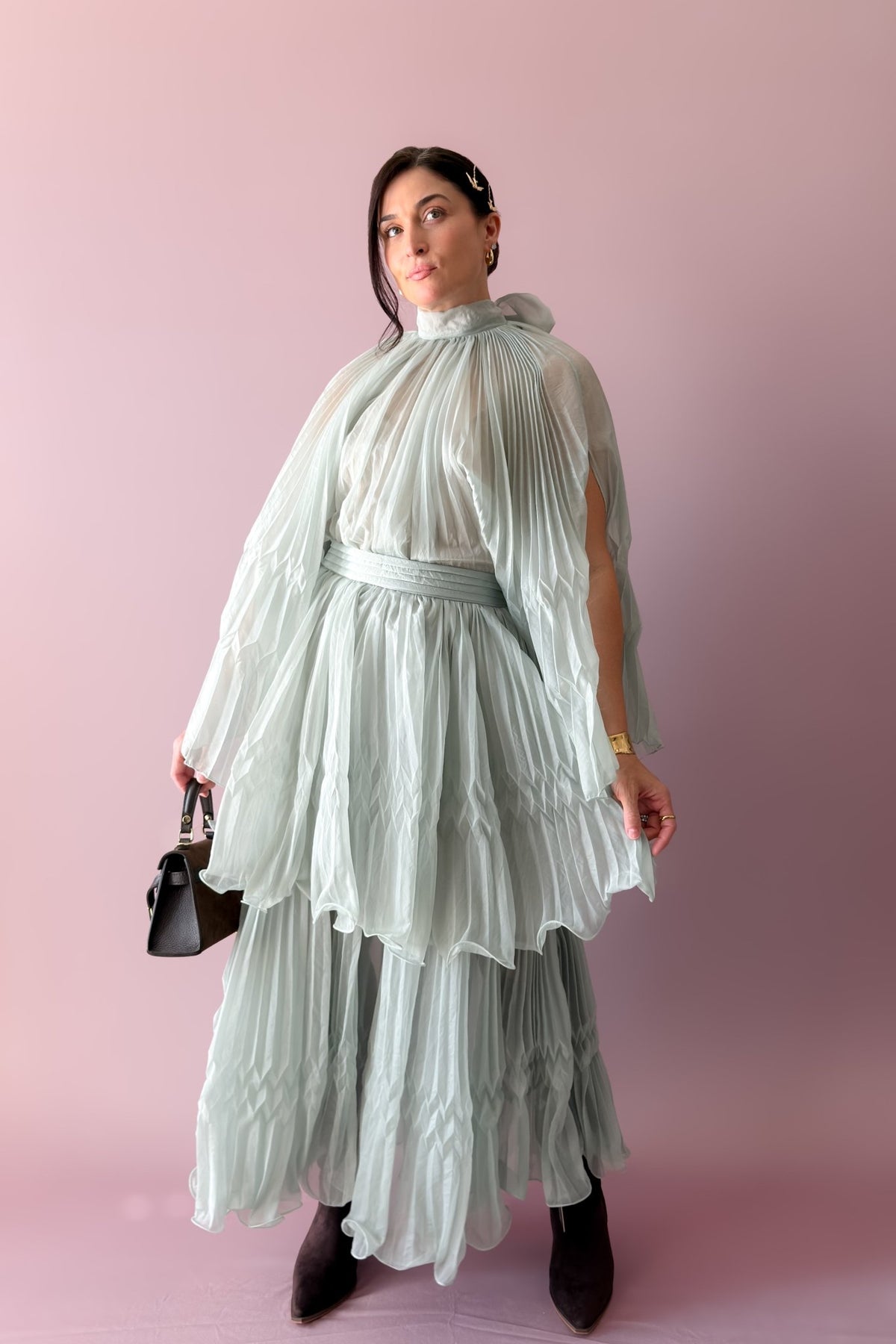 Mint tiered pleated maxi skirt styled with a neutral tank and brown handbag