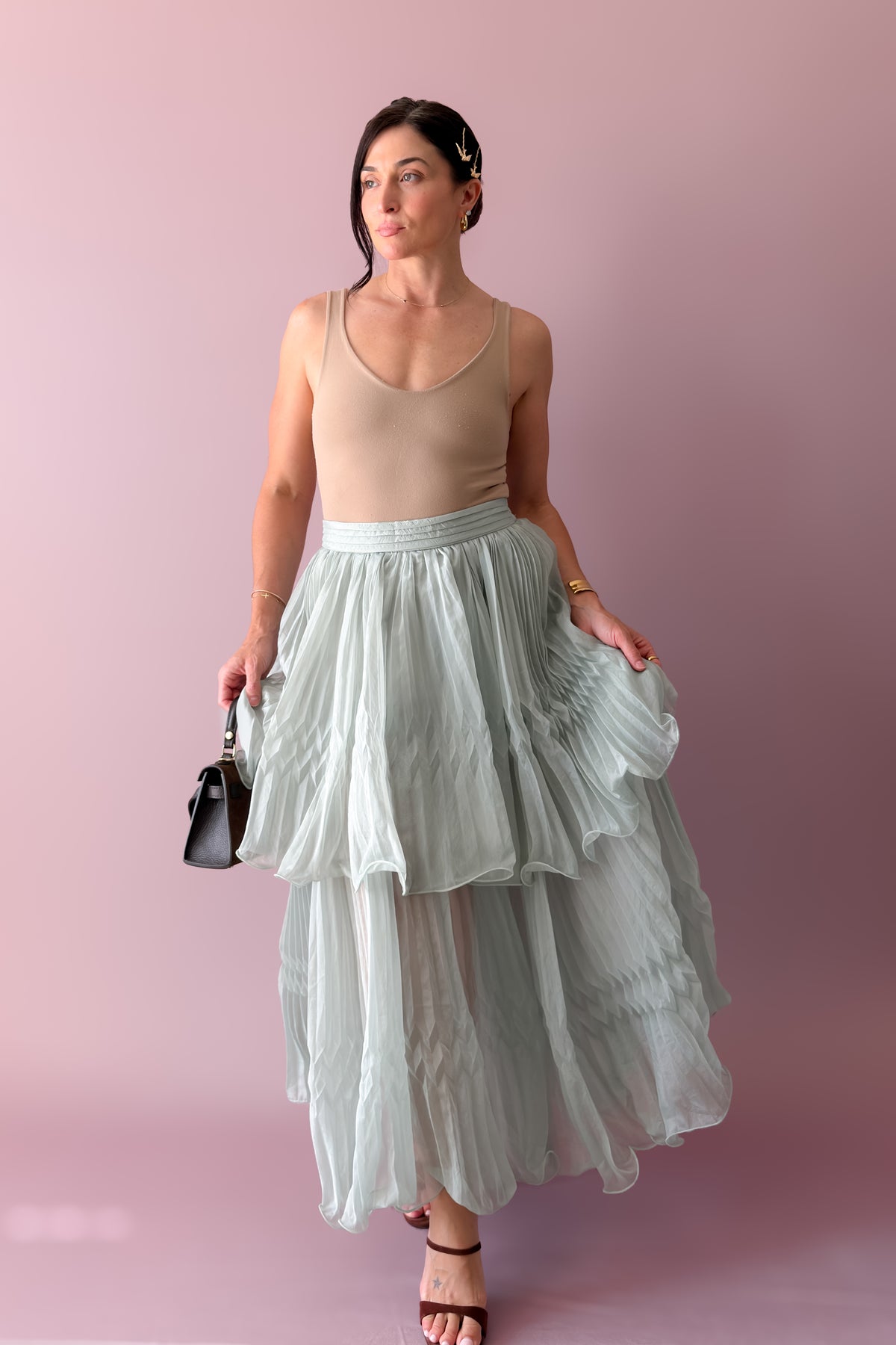 Mint pleated chiffon two-piece set with flowing cape top and layered tiered maxi skirt for a wedding guest outfit