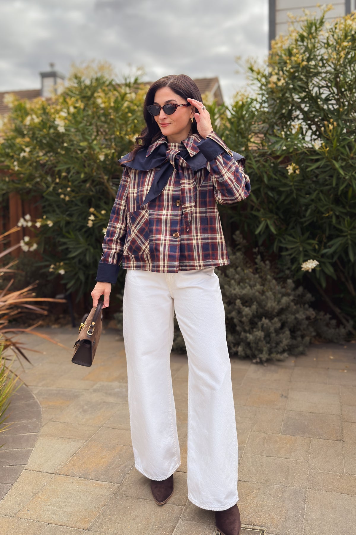 Women’s reversible fall jacket in navy and brown plaid with relaxed fit and statement cape