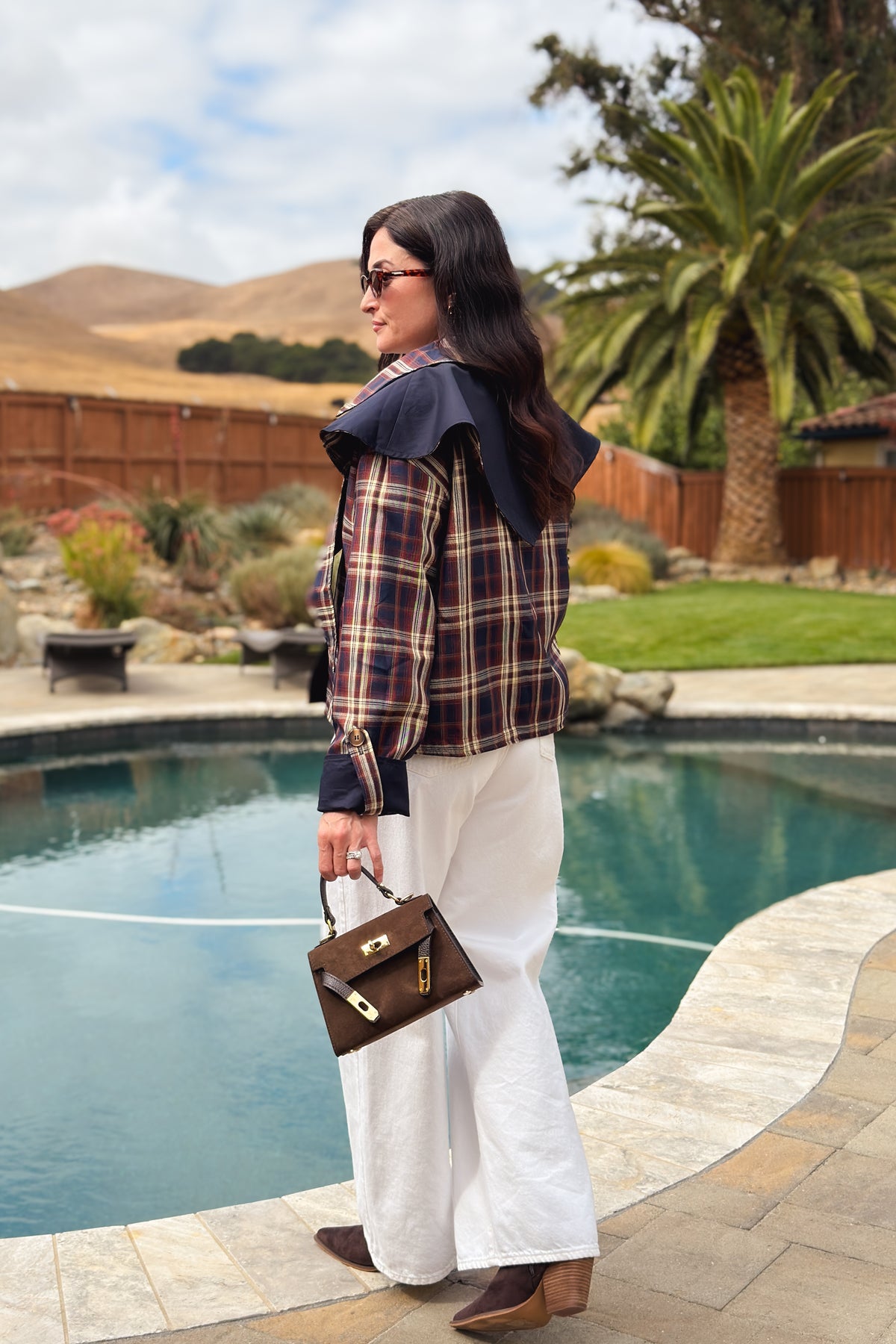 Women’s navy jacket with reversible brown plaid design and detachable cape collar detail