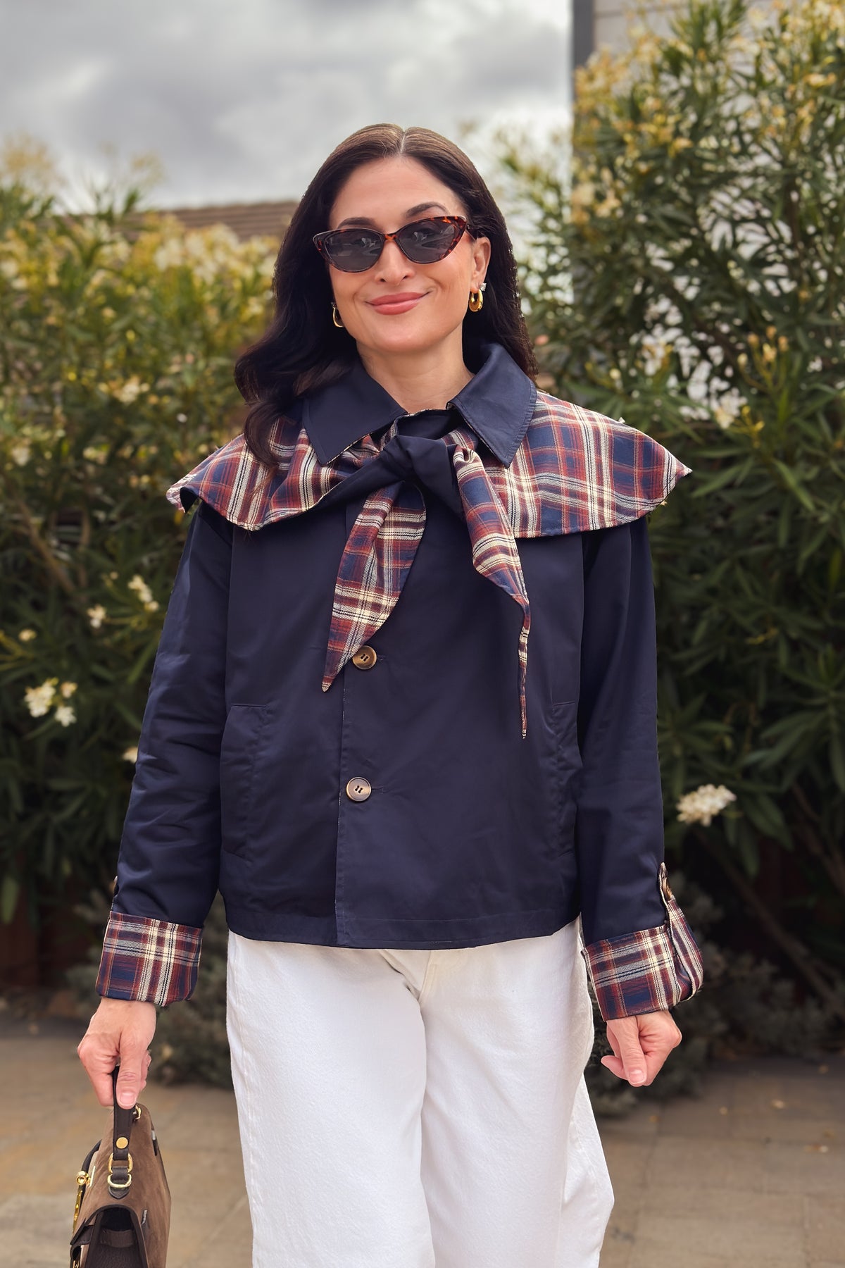 Women’s boxy fall jacket with reversible navy and plaid sides, button front, and removable cape detail