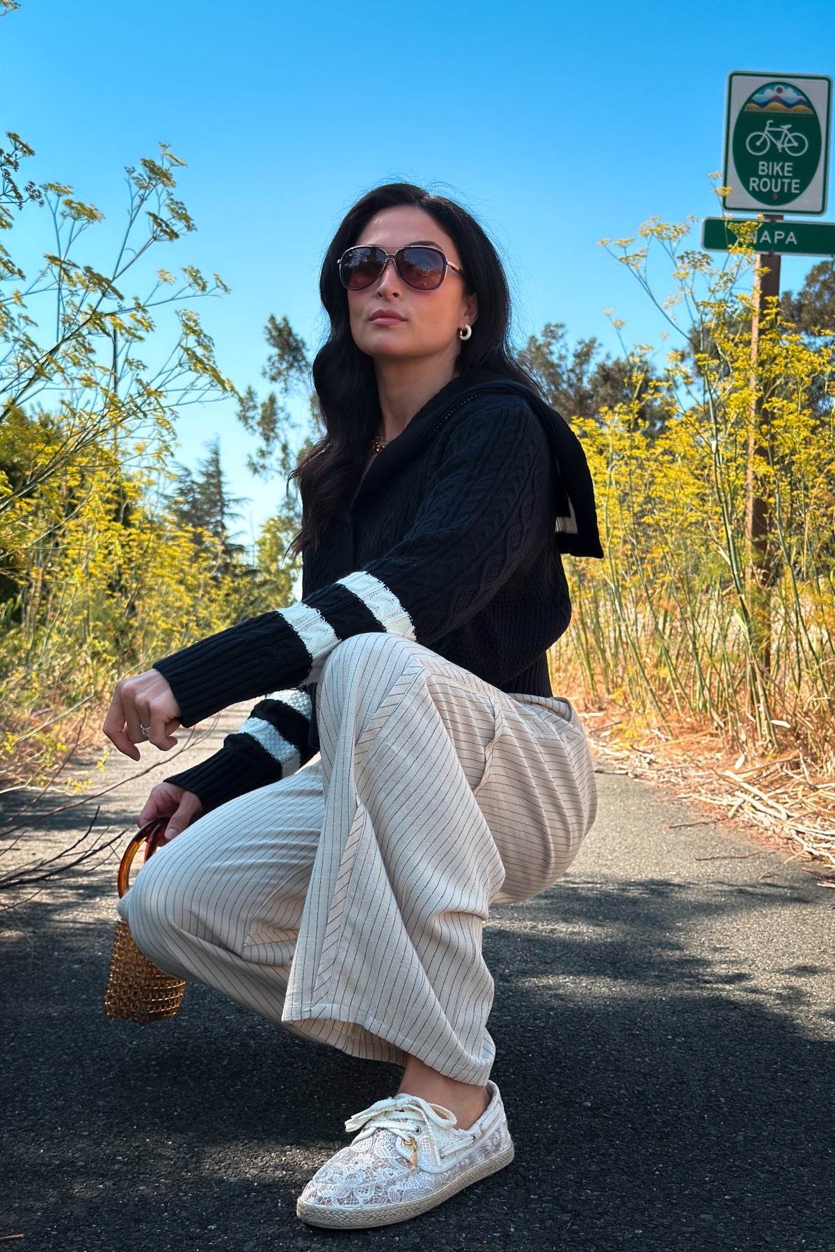 Soft navy knit cardigan with ivory sailor collar and cable knit texture, styled as an elevated fall layering piece.