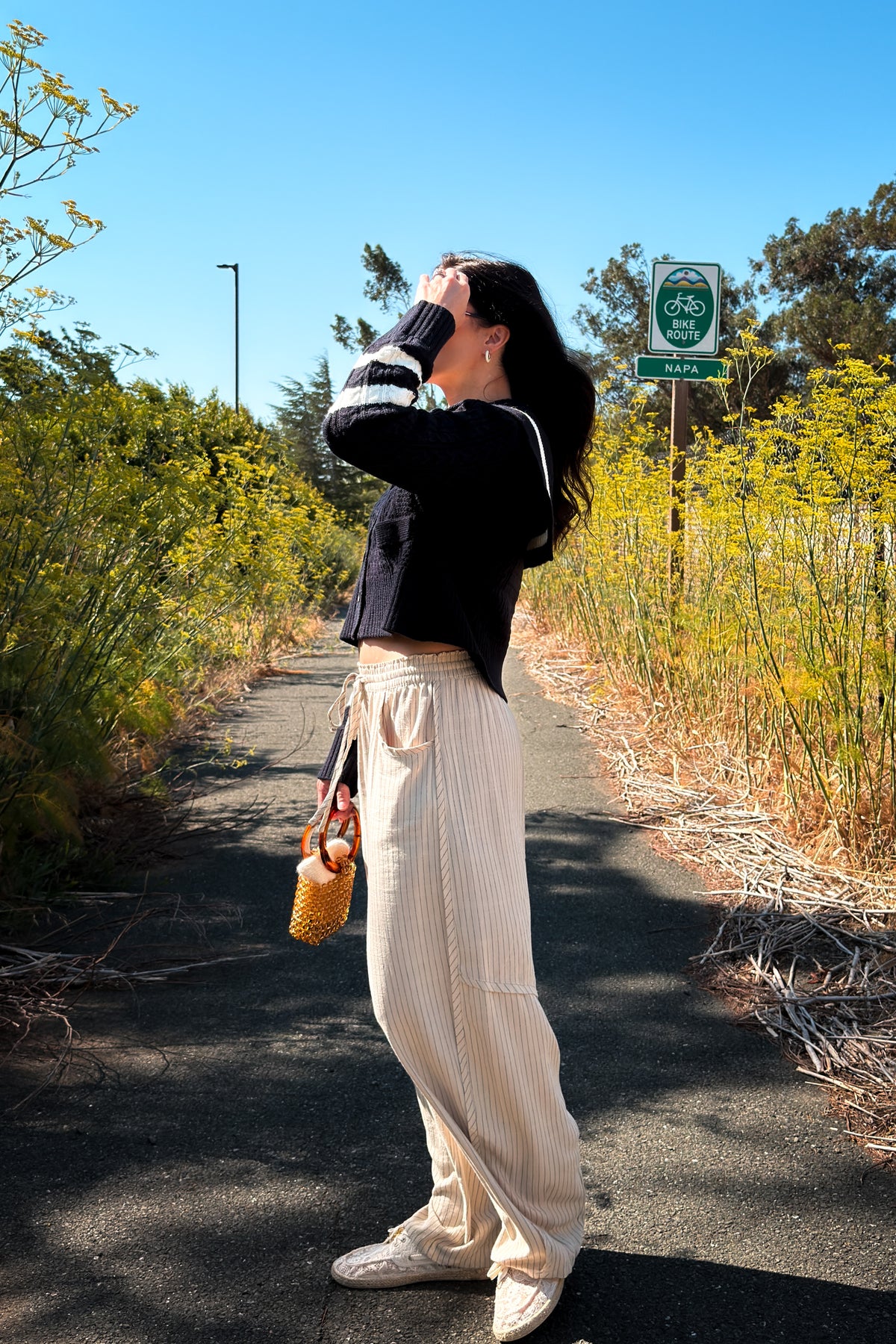 Navy and ivory cable knit cardigan with slightly cropped length, oversized collar, and soft stretchy knit fabric.
