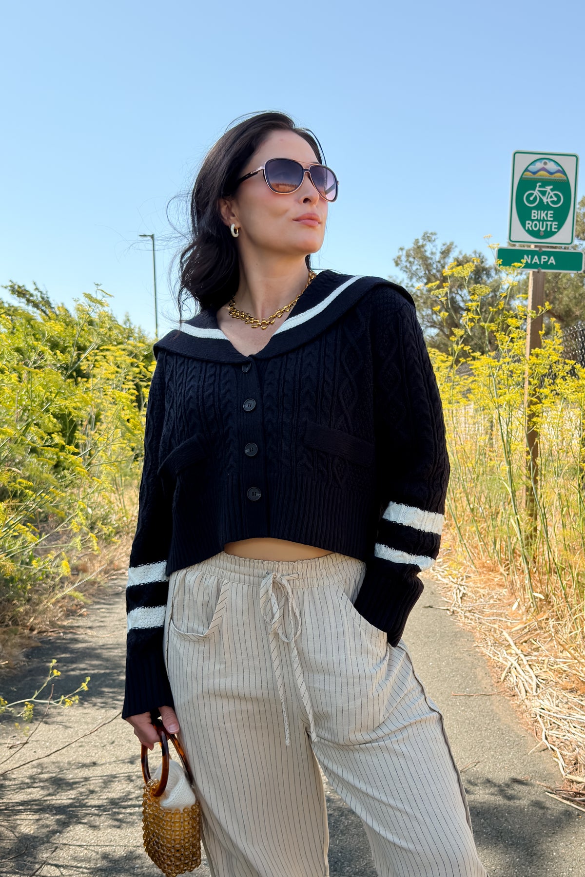 Cropped navy cable knit cardigan for women with oversized sailor collar, button front, and ivory striped detailing.
