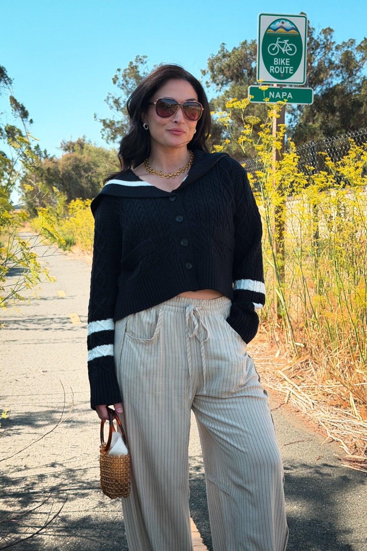 Heritage inspired navy cardigan sweater with ivory sailor collar, cable knit texture, and relaxed button front design.