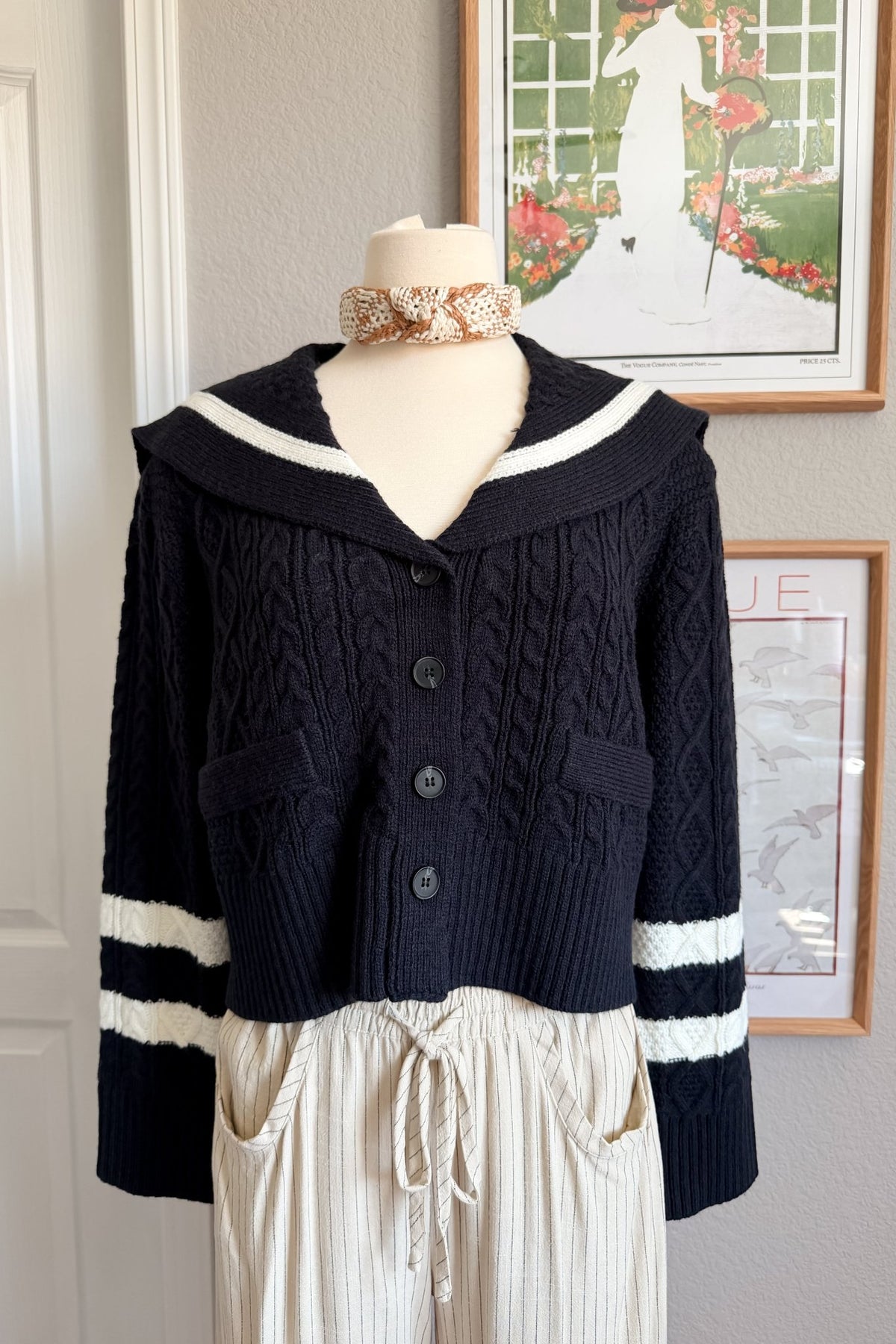 Navy cropped cardigan for women styled with cream striped wide leg pants and gold accessories for an elevated everyday outfit.