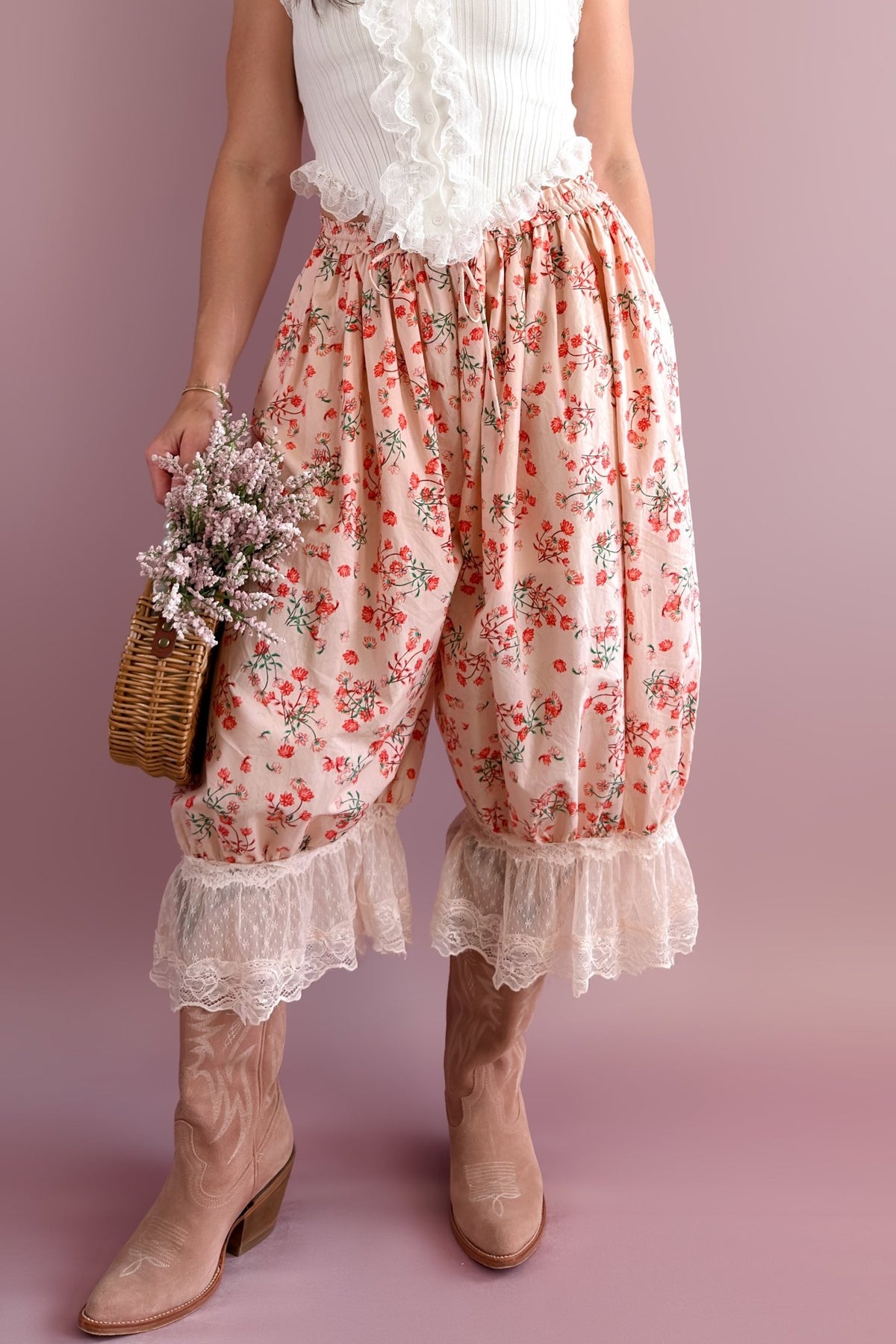Blush pink floral bloomer pants with ivory lace ruffle hems styled with a white lace tank and taupe western boots
