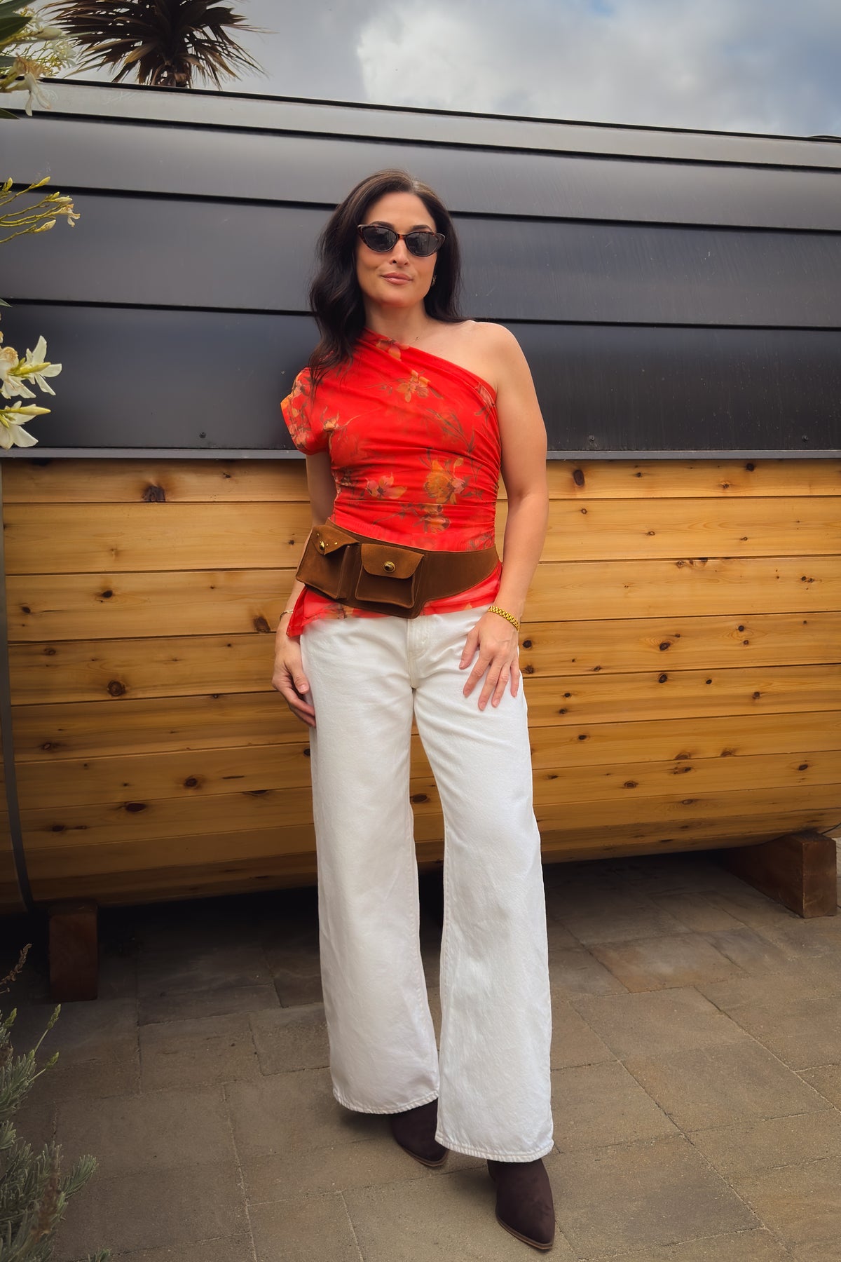 Vibrant red orange floral one shoulder top with fitted waist and semi sheer mesh