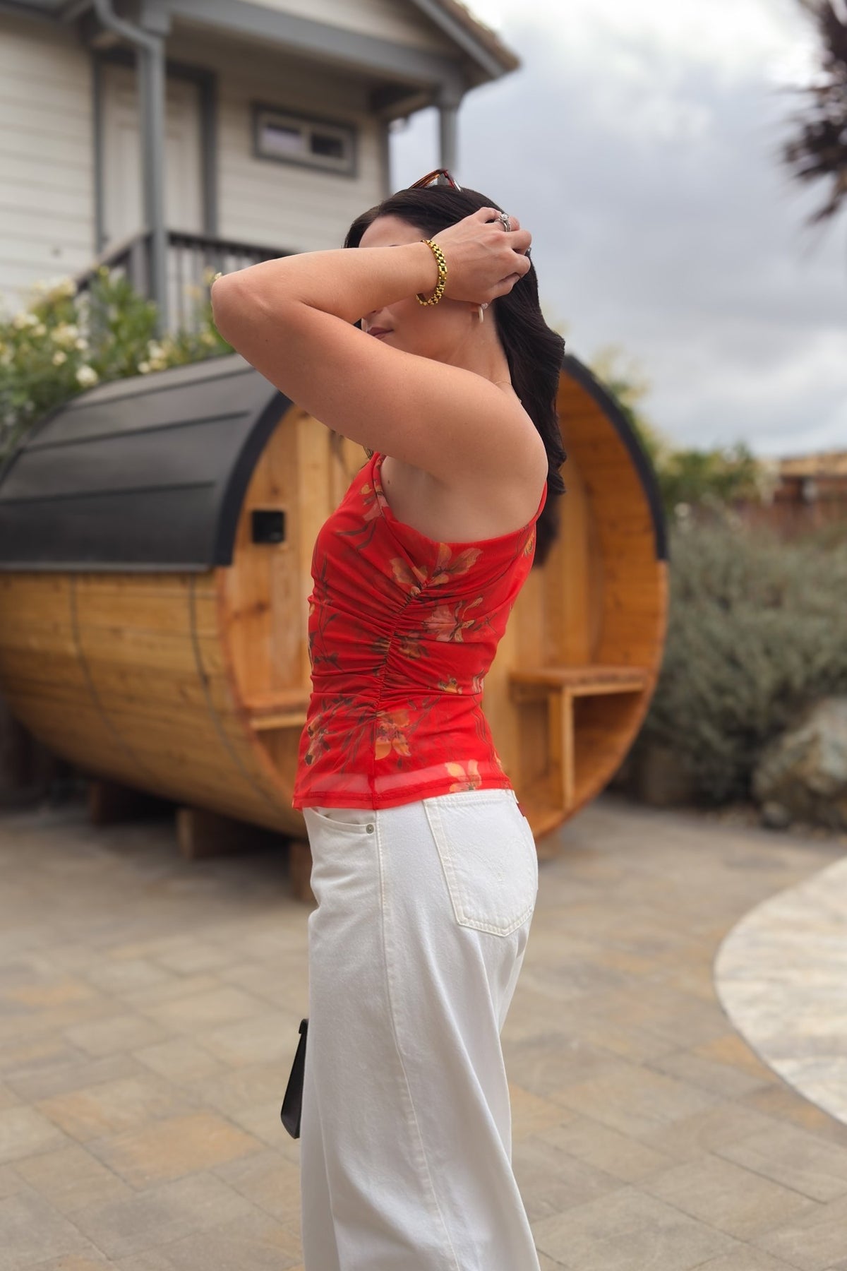 Red orange floral mesh top styled with white jeans for an elevated casual outfit