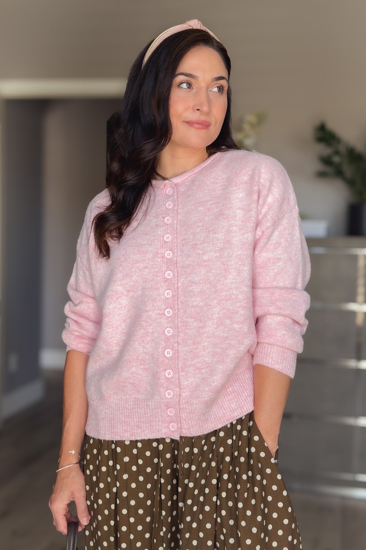 Relaxed fit pink cardigan sweater with soft stretch knit, long sleeves, and functional front buttons.