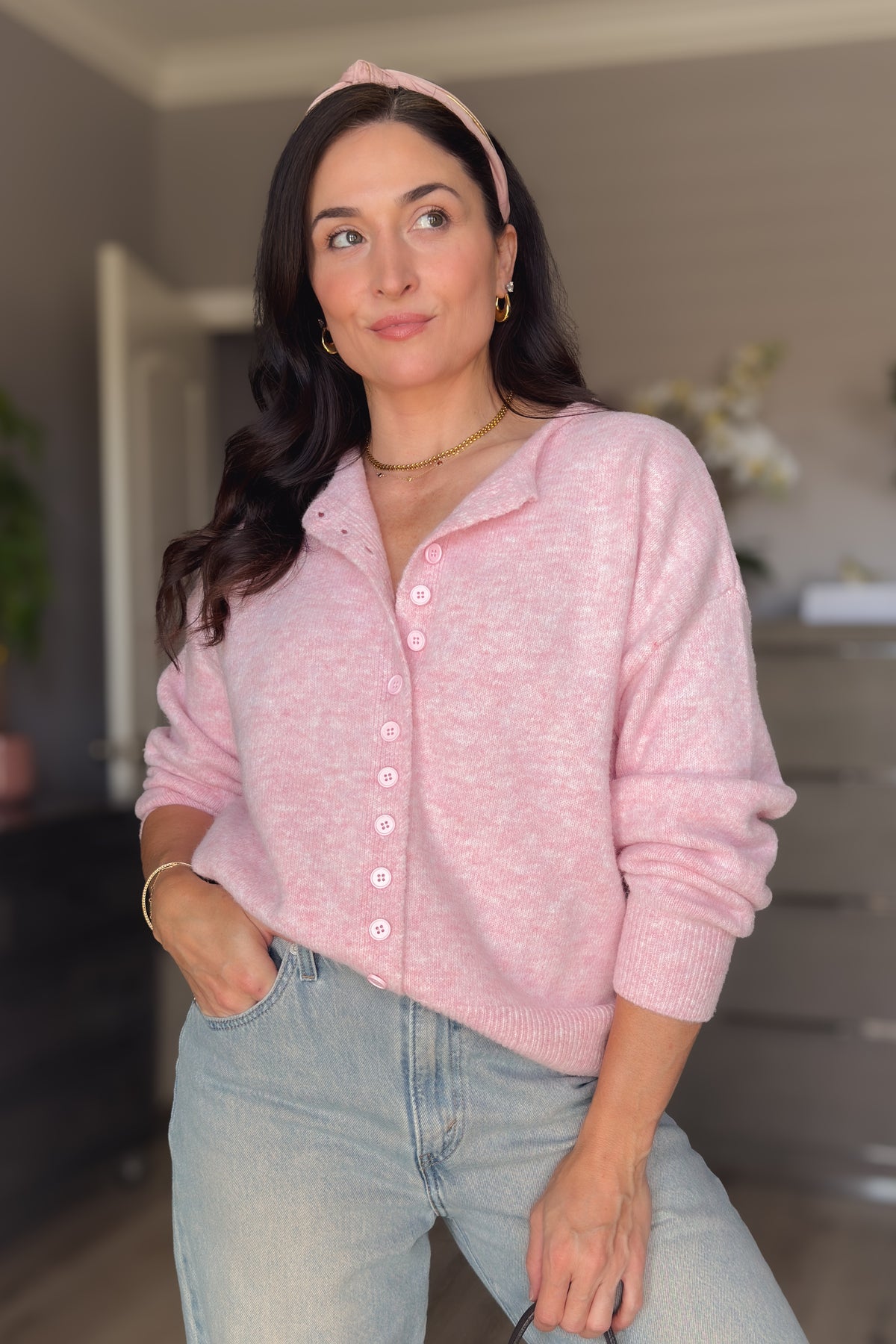 Soft pink knit cardigan for women with a relaxed silhouette, ribbed cuffs, and button front styling.