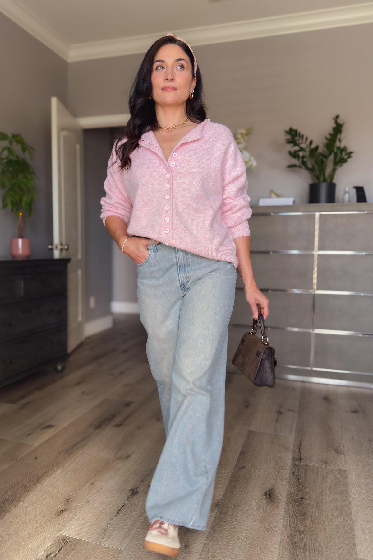Light pink button up cardigan paired with wide leg jeans for a feminine casual layered outfit.