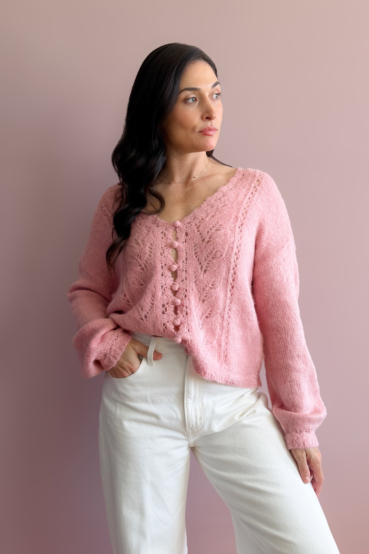 Soft pink lightweight sweater with relaxed fit and feminine sleeve shape styled for year-round layering