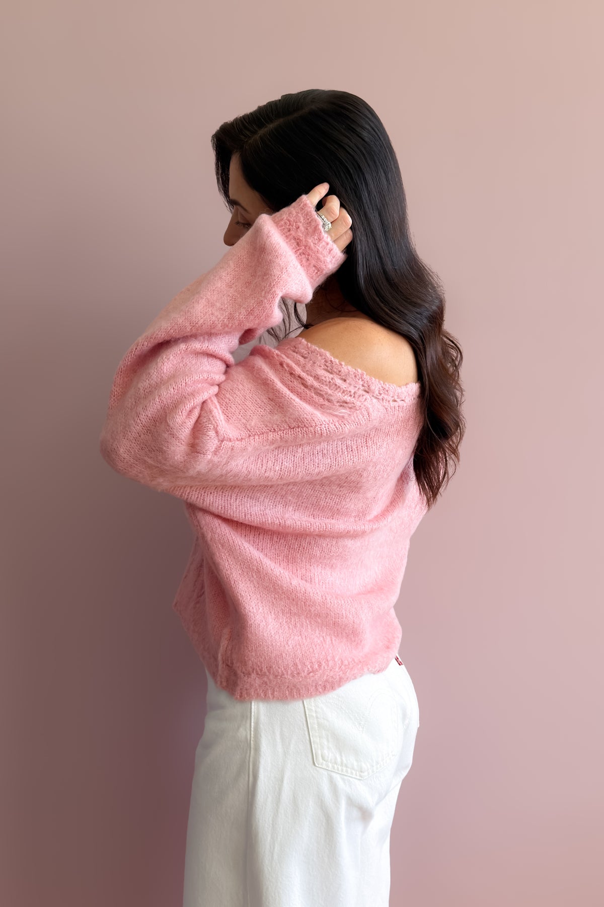 Women’s soft pink sweater styled with white pants for a simple feminine everyday outfit