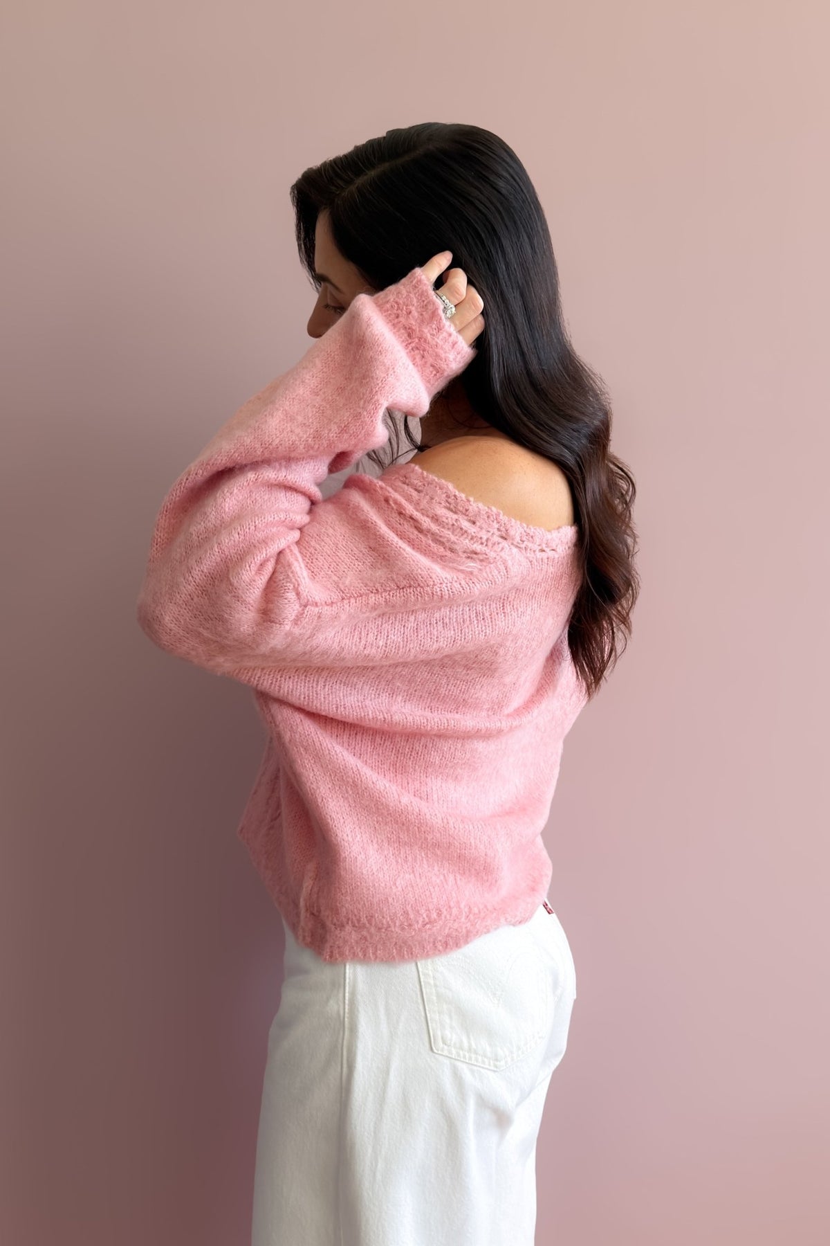 Women’s soft pink sweater styled with white pants for a simple feminine everyday outfit