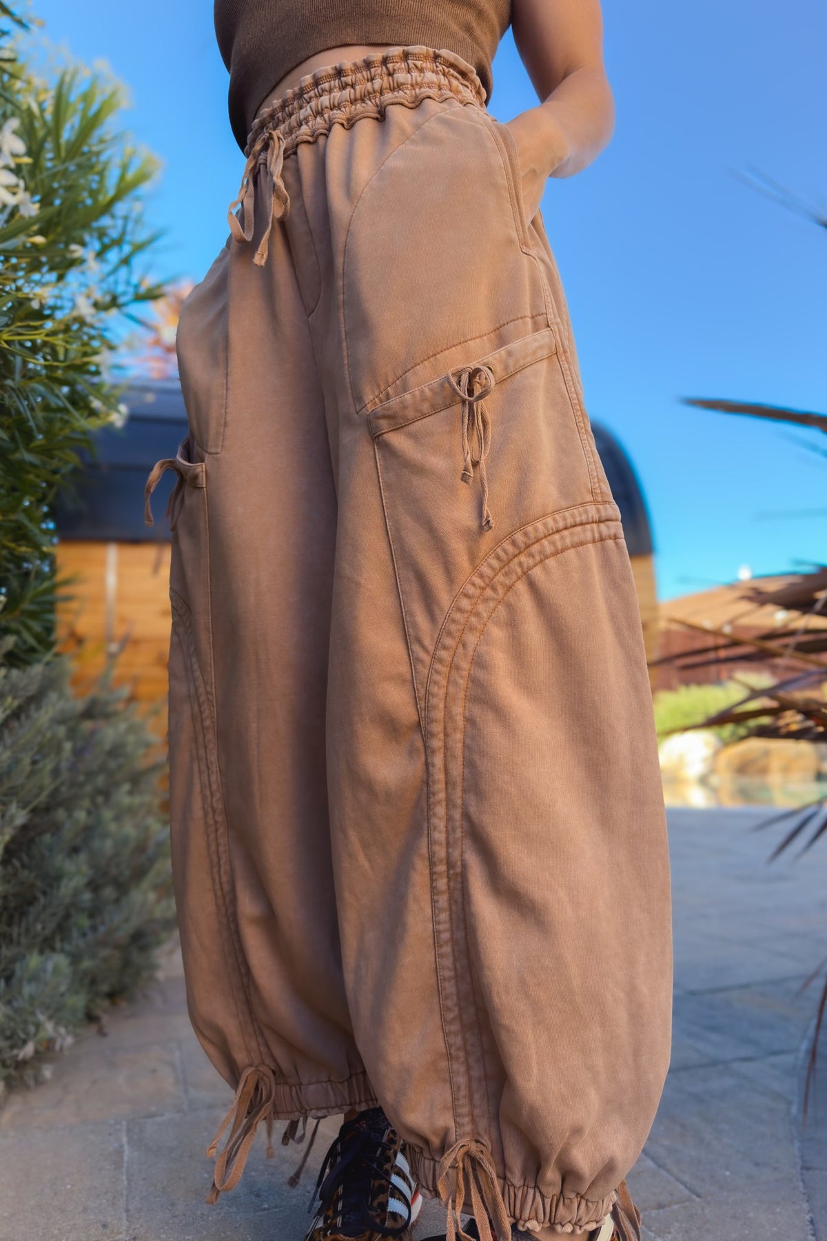 Women’s tan cargo pants with elastic drawstring waist and relaxed wide leg silhouette