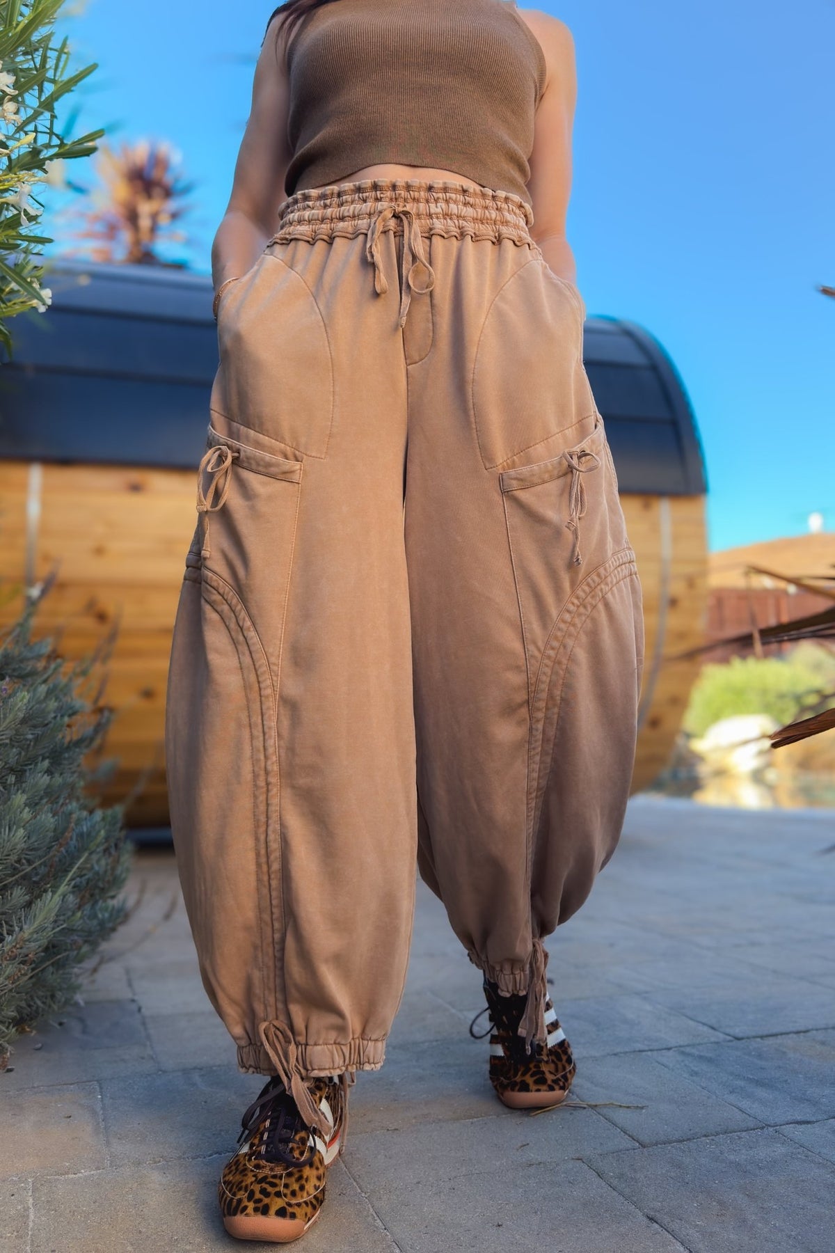 1. Tan mineral wash wide leg pants with relaxed utility silhouette styled with leopard sneakers