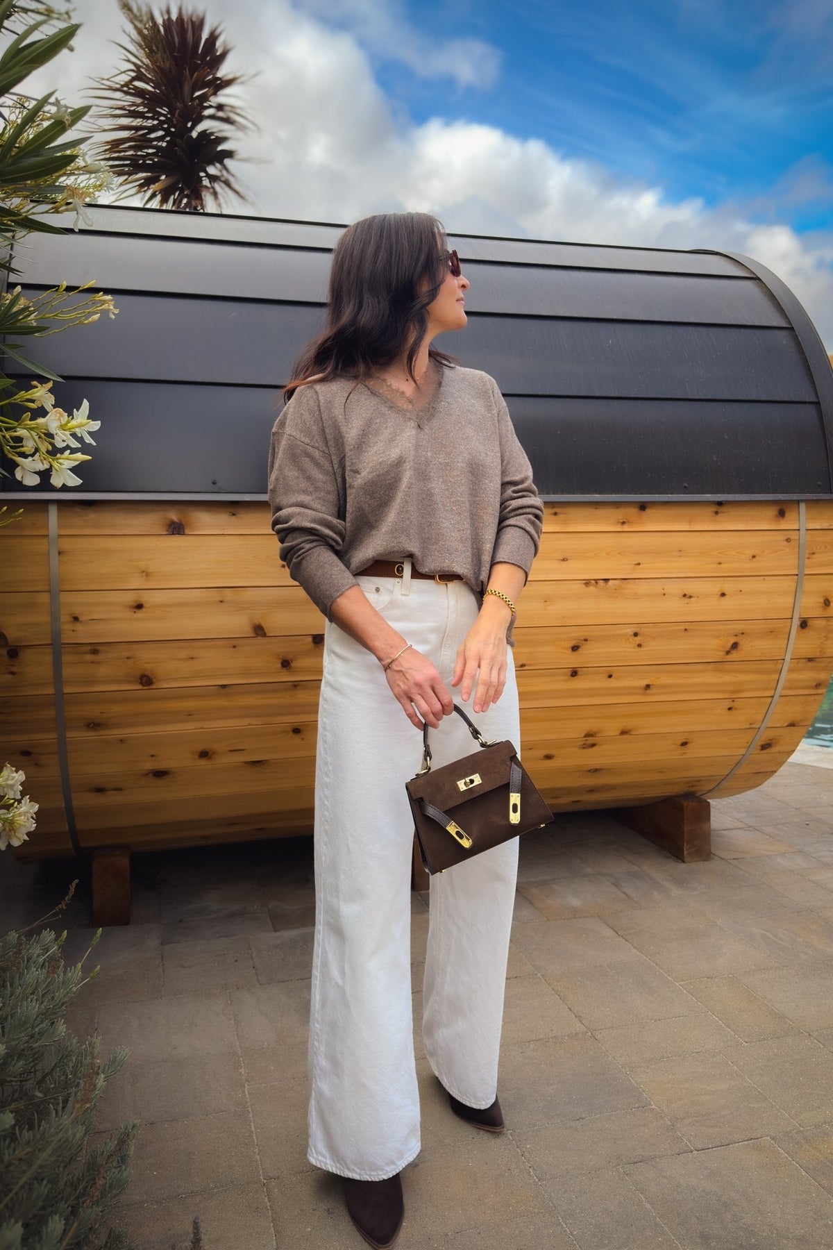 Taupe brown lace trim sweater styled with white wide leg jeans and ankle boots