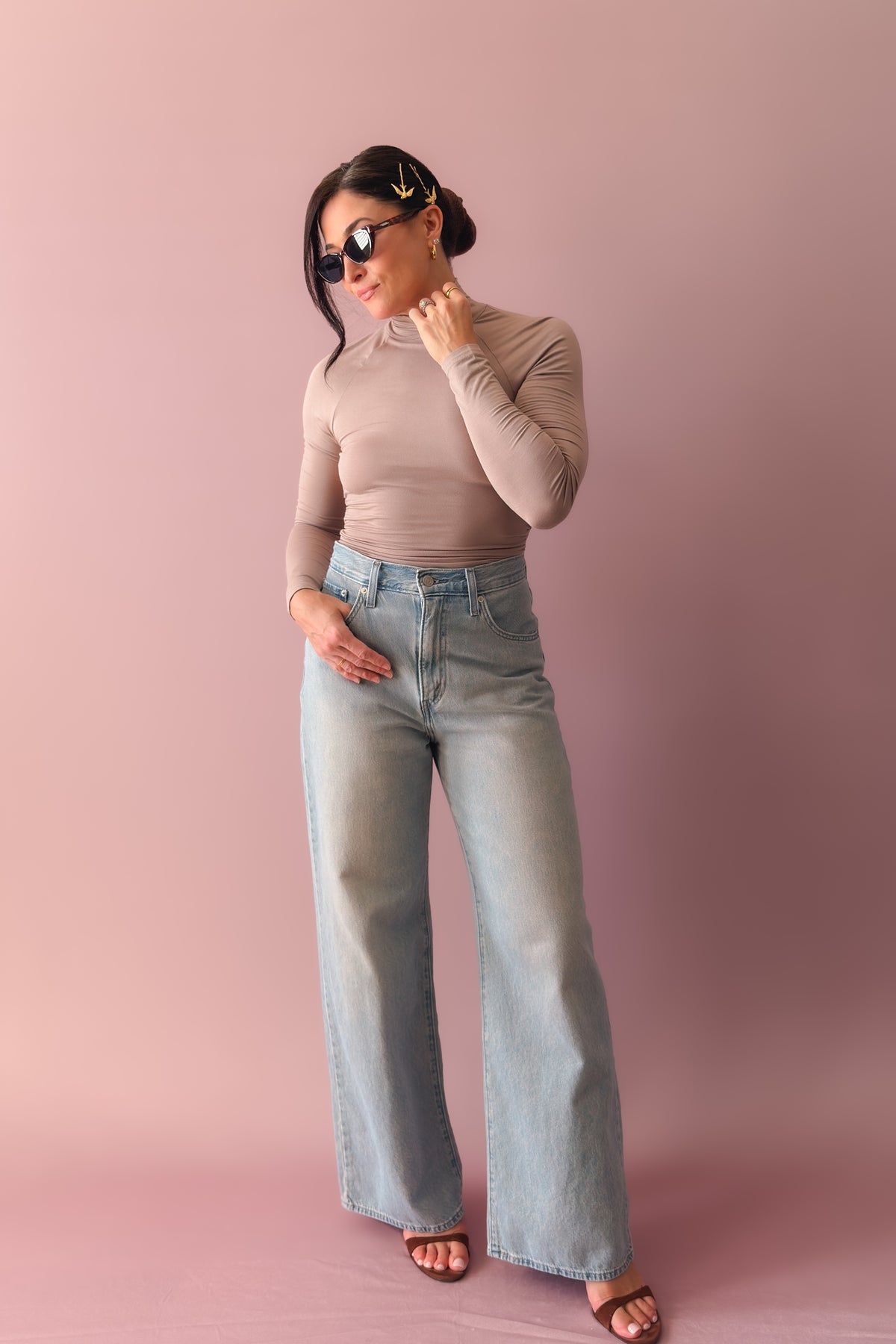 Side view of taupe open back top with fitted sleeves and high stretch fabric