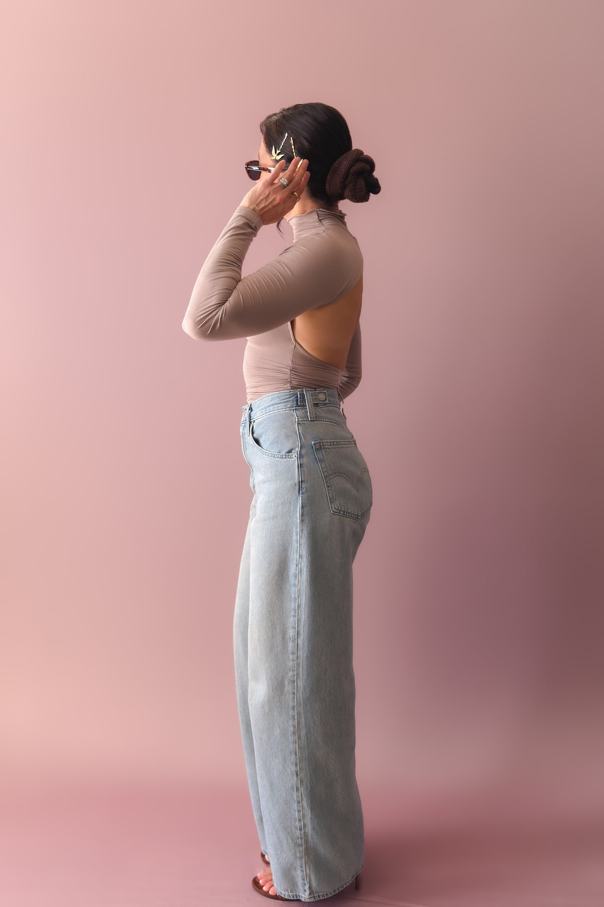 Buttery soft taupe open back top styled with wide leg denim and heels