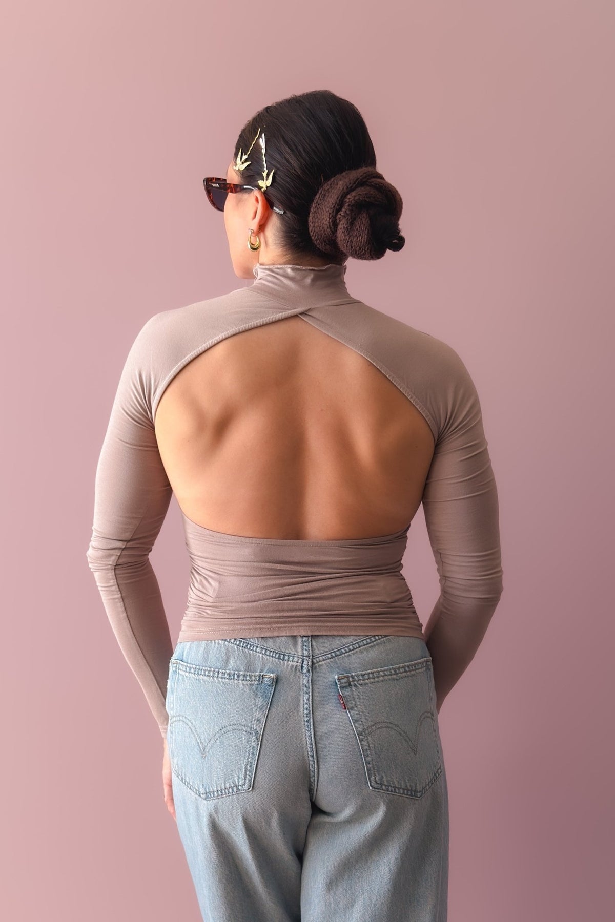 Women’s high neck taupe top with statement open back and stretch-to-fit silhouette
