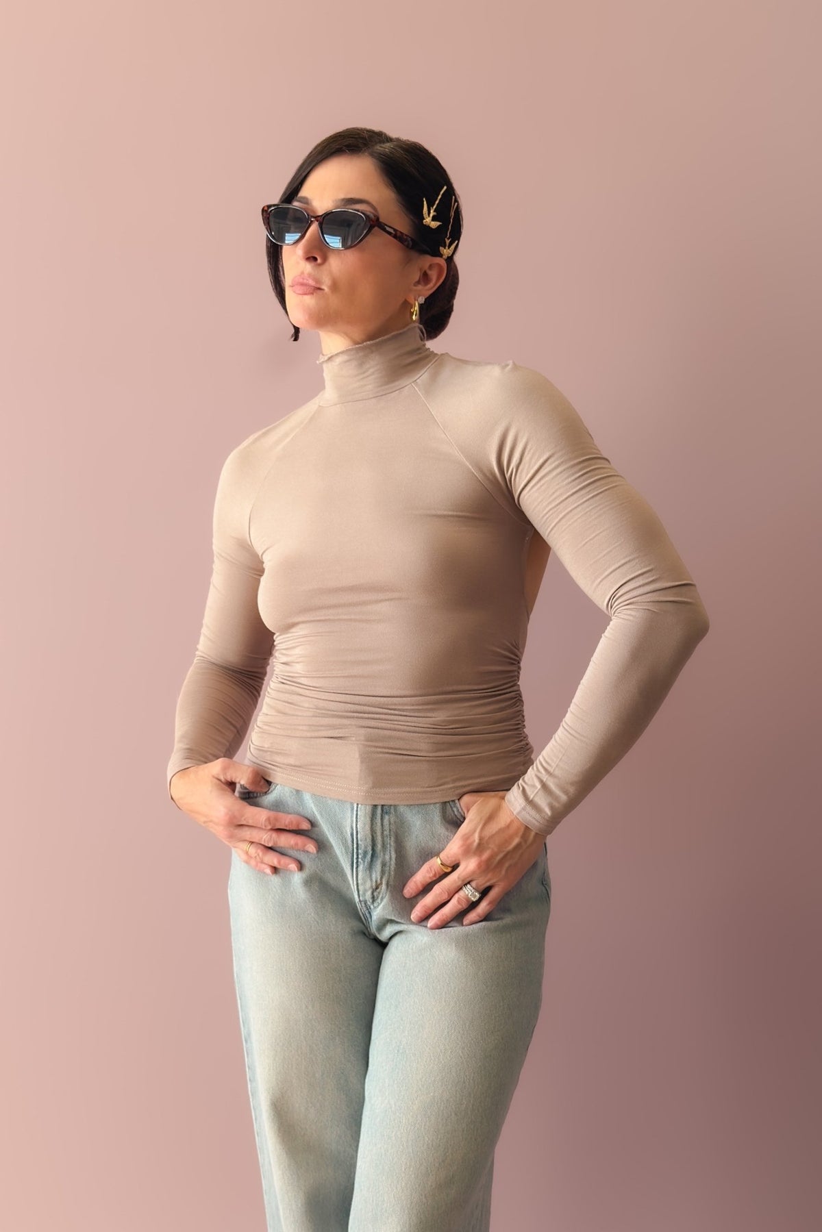 Women’s taupe open back long sleeve top with high neckline and soft stretch fabric