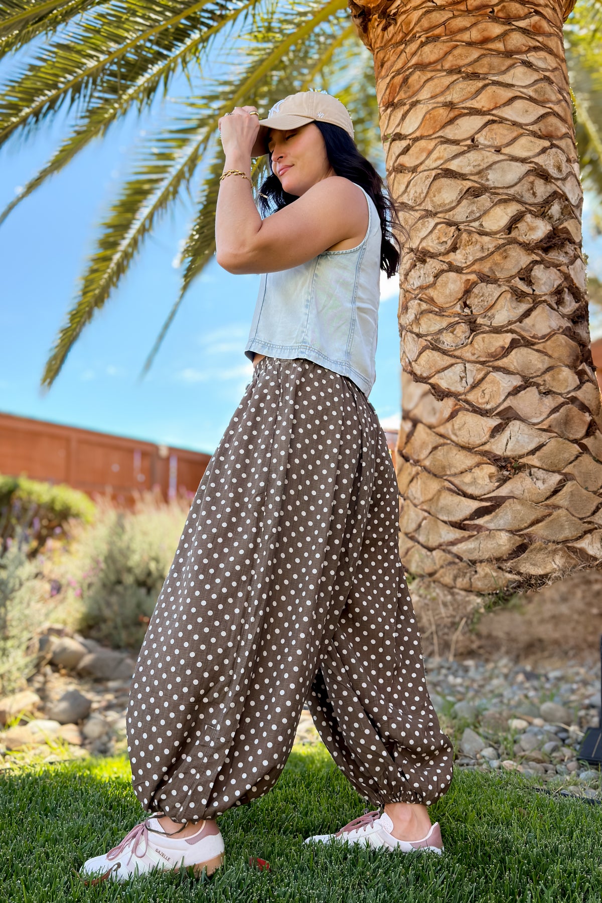 Front view of washed brown balloon pants with an elastic drawstring waist and adjustable ankle ties.