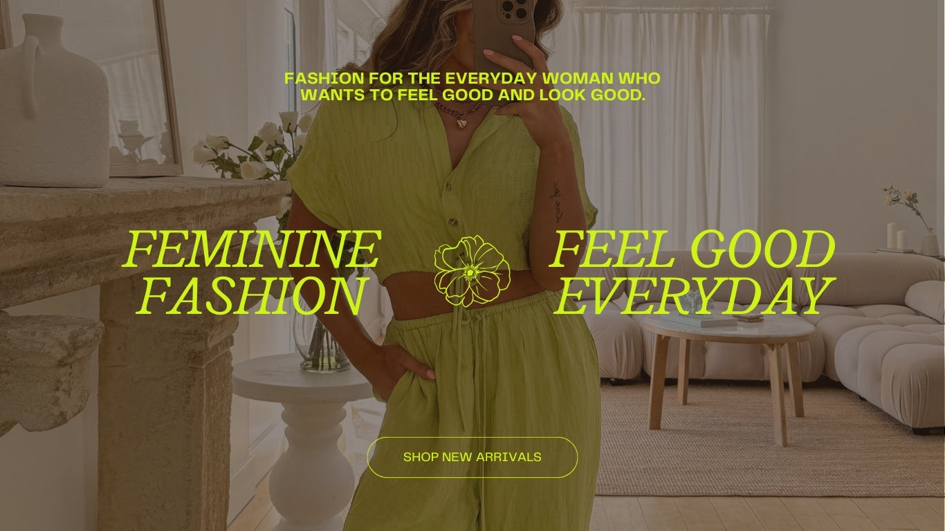 A woman standing in a stylish, modern living room wearing a vibrant green two-piece outfit. The text overlay reads "Fashion for the everyday woman who wants to feel good and look good," "Feminine Fashion," and "Feel Good Everyday." A "Shop Now" button is also visible. The image promotes feminine fashion designed to make women feel good every day.