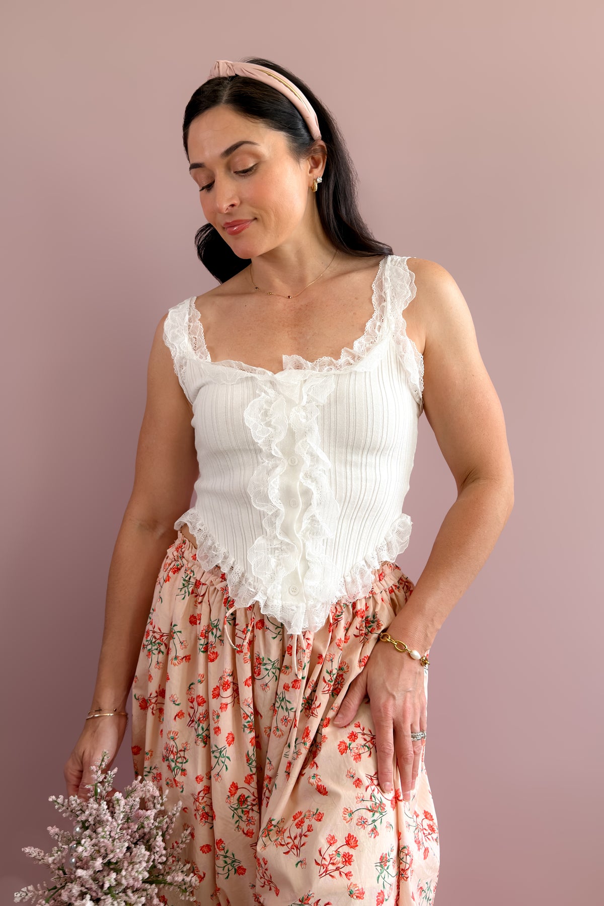Feminine white tank top with ruffle lace trim and stretchy ribbed fabric for year-round layering
