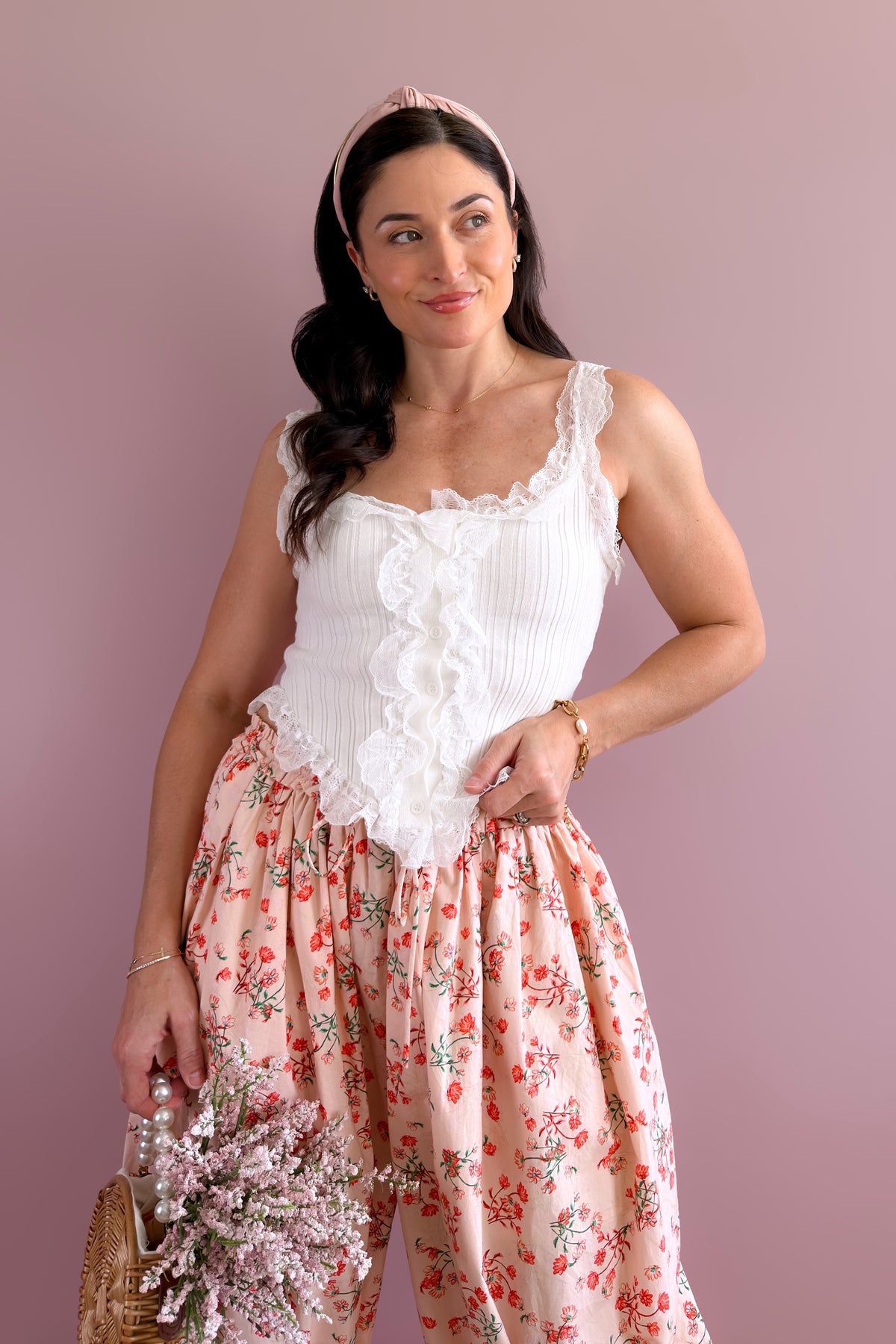 White lace ruffle button front tank paired with floral statement pants for a soft romantic look
