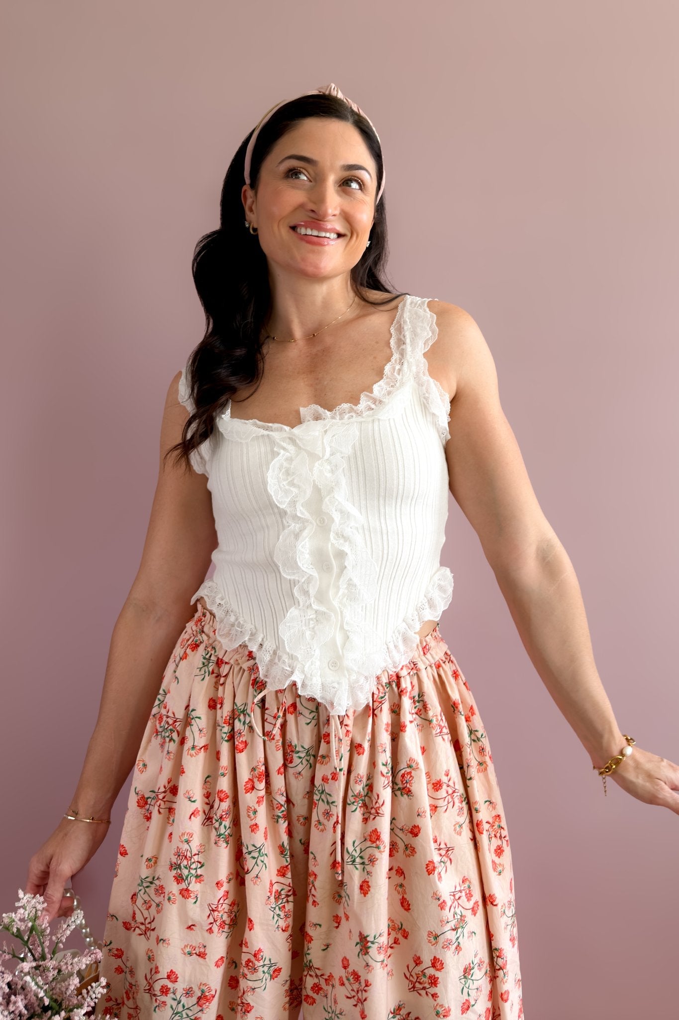 White lace ruffle button front tank paired with floral statement pants for a soft romantic look