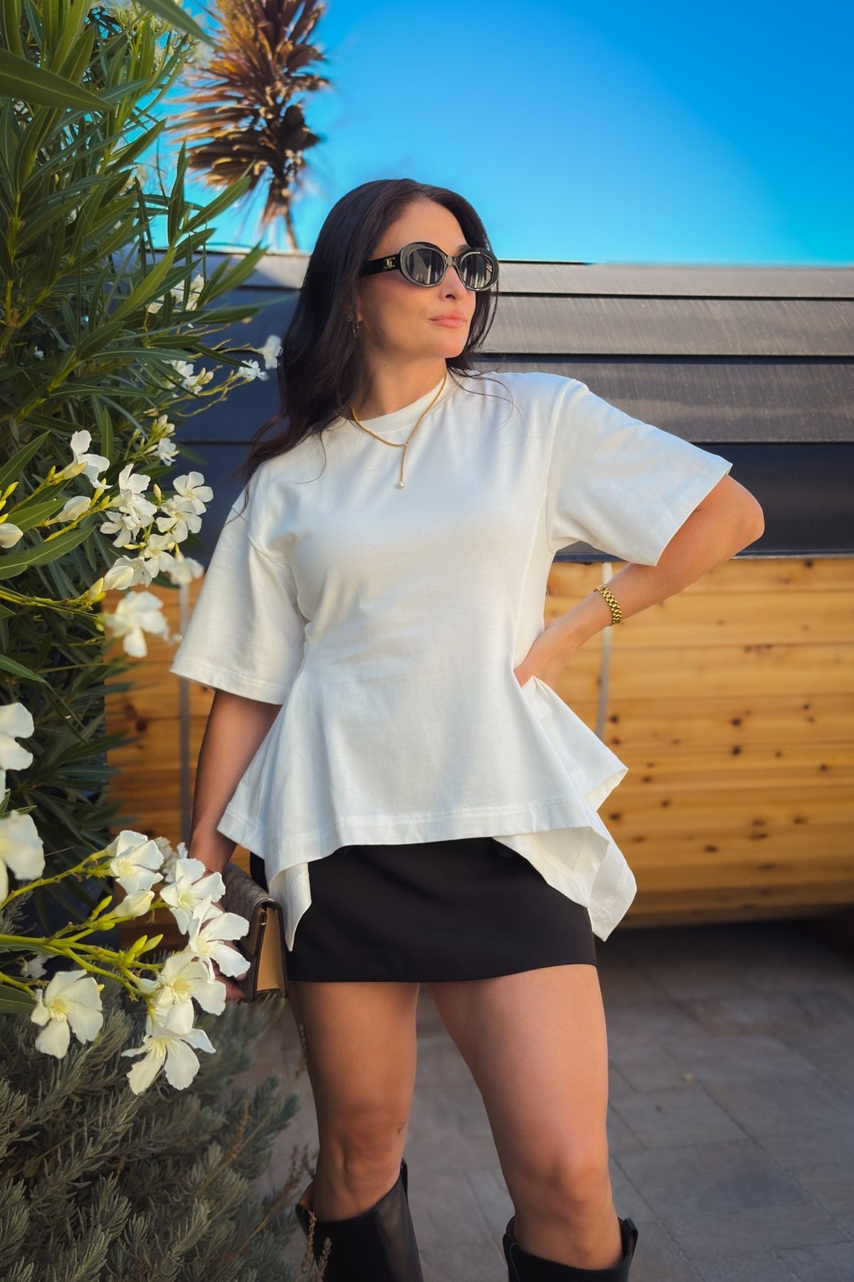 White structured cotton peplum T-shirt with oversized short sleeves and a flattering waist-defining silhouette.