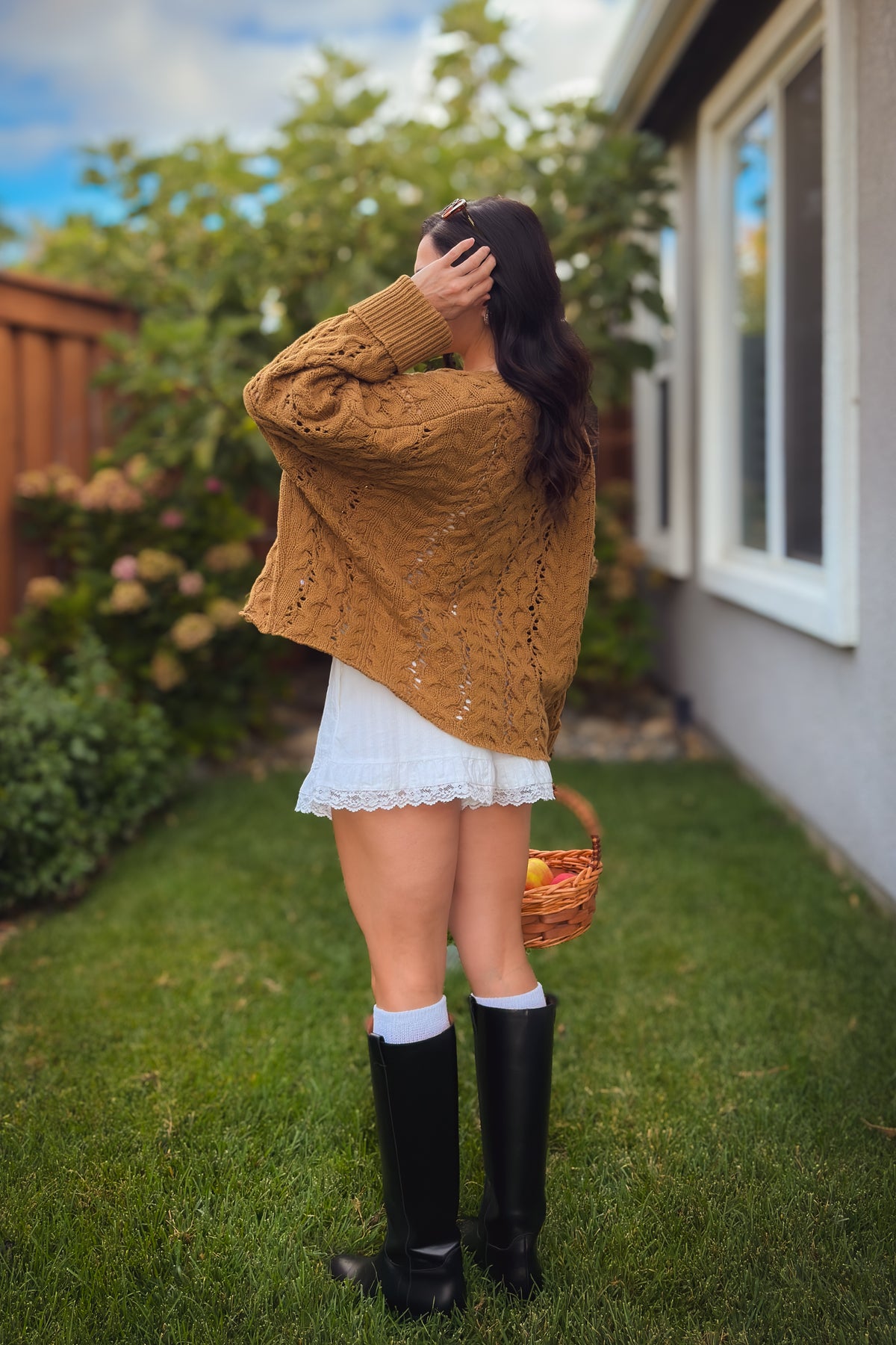 Women’s camel cable knit sweater with relaxed oversized fit and button neckline