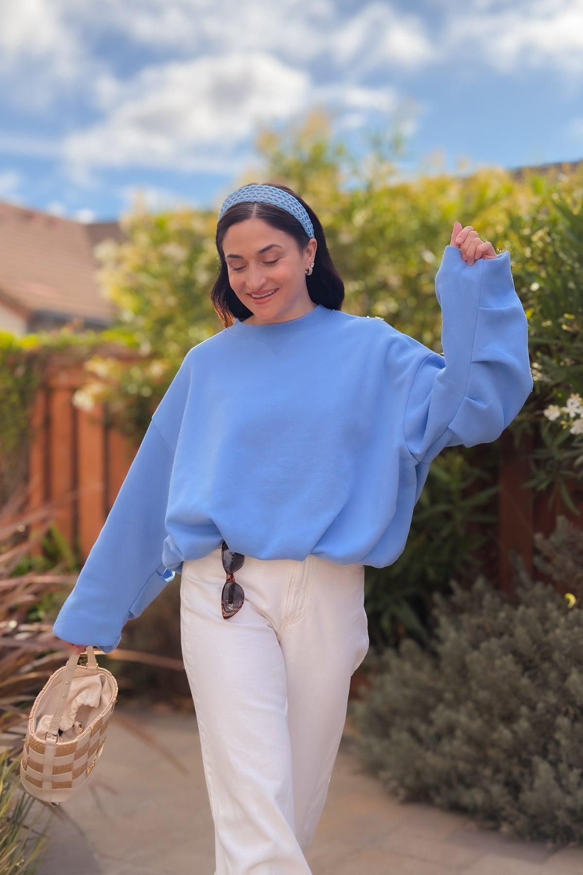 Women’s casual cornflower blue sweatshirt styled with white denim and ankle boots