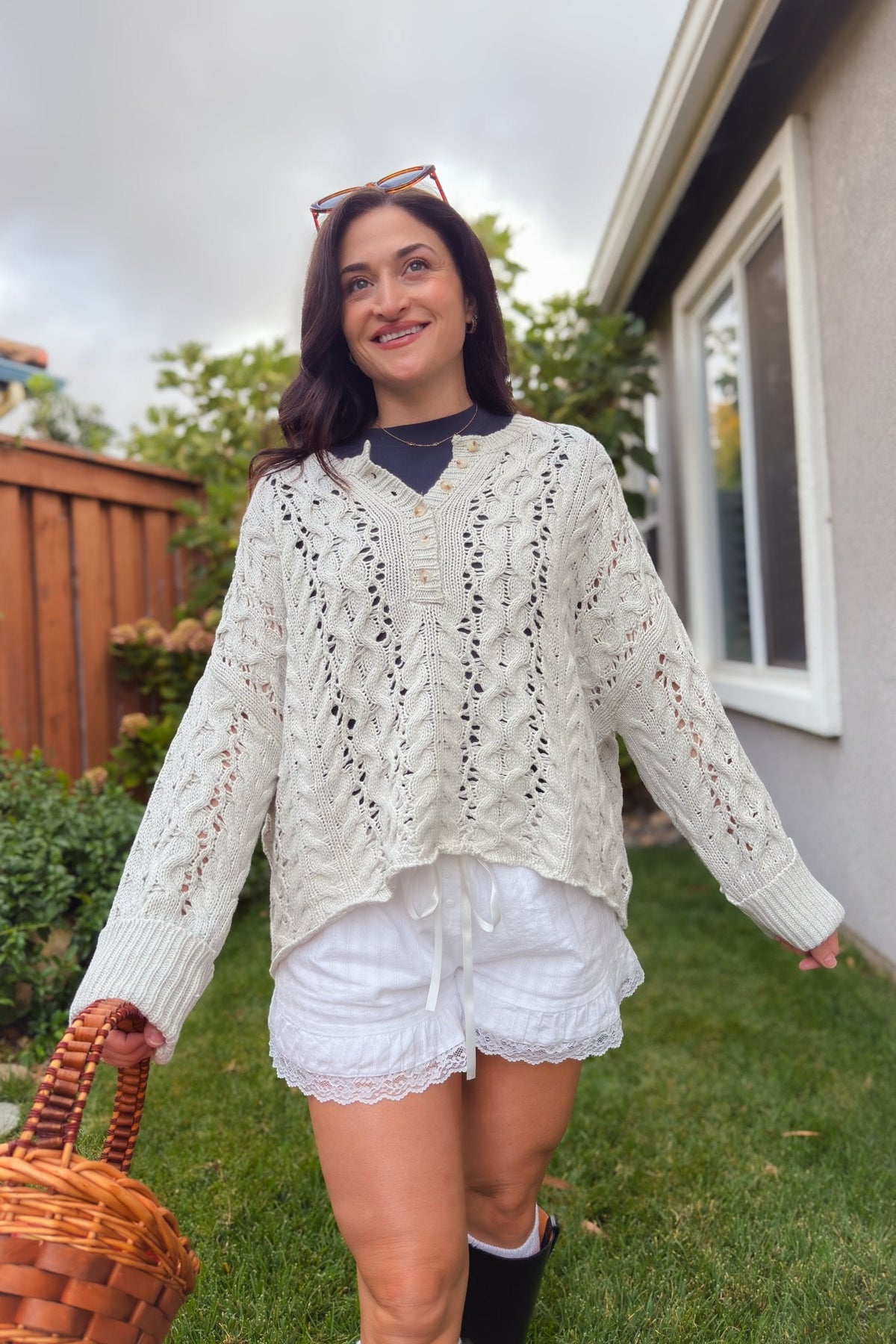 Light gray cotton blend sweater with cable knit pattern, wide cuffs, and relaxed boxy silhouette.
