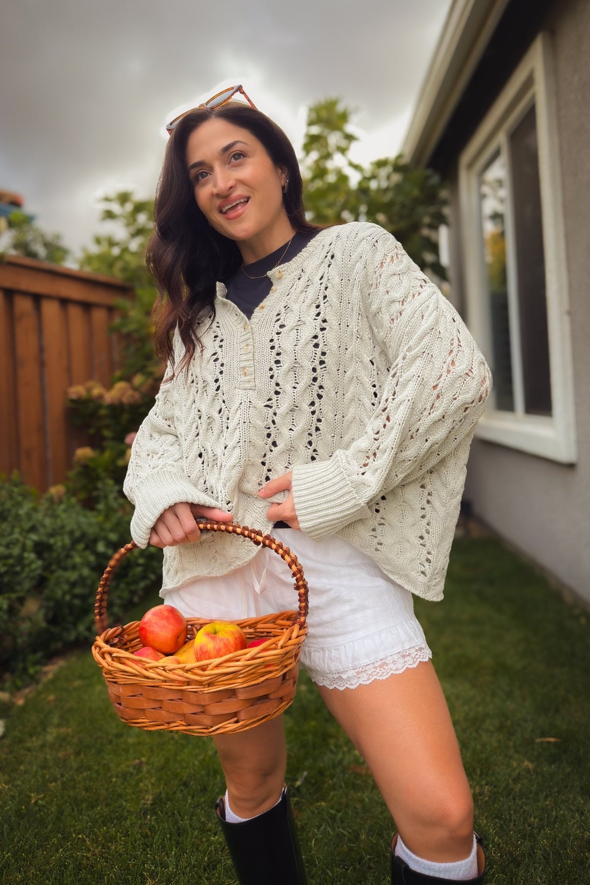 Women’s light gray open knit sweater with button Henley neckline and slouchy drop shoulder fit.