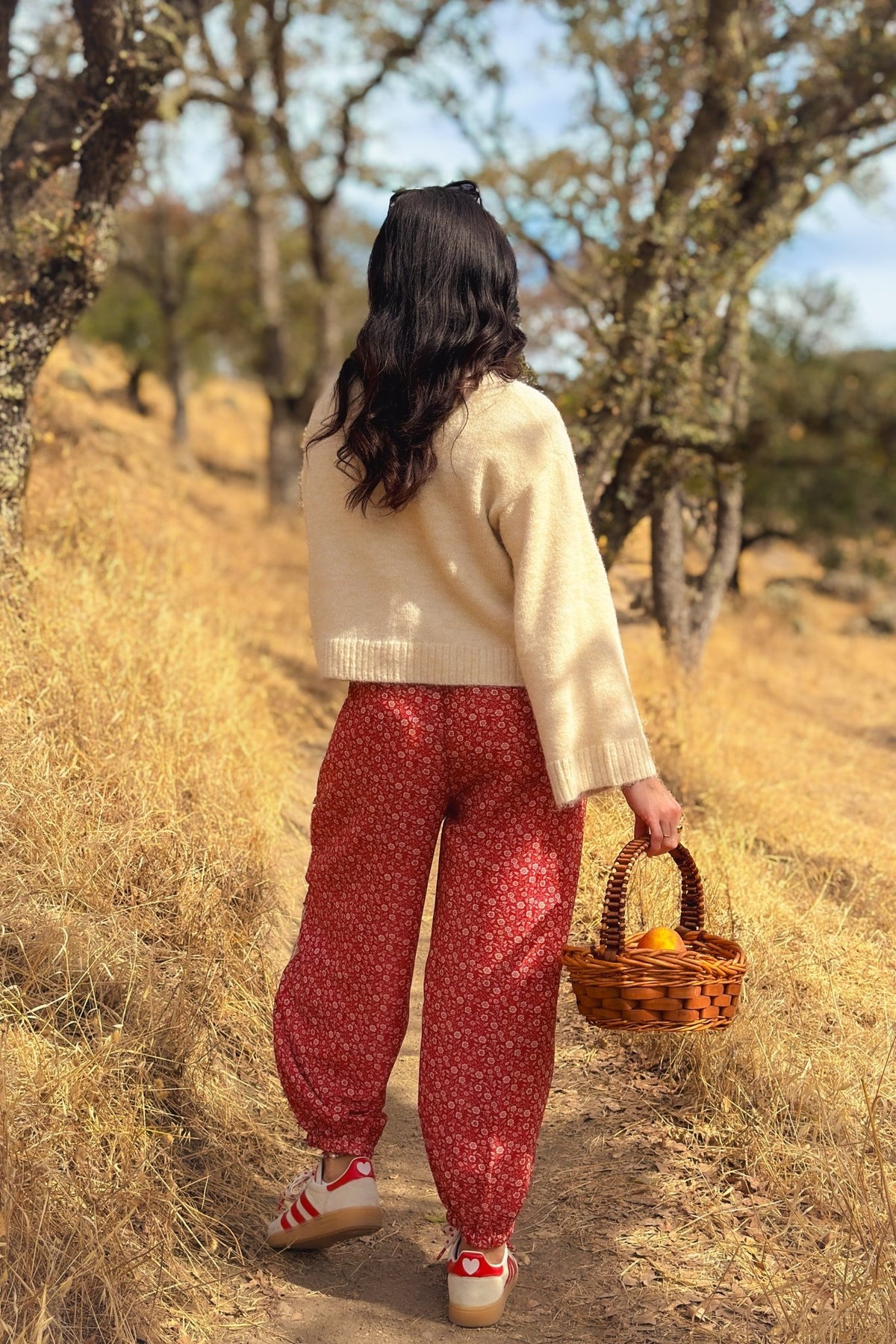 Floral patchwork statement pants for women in muted red with roomy balloon legs and adjustable waist tie