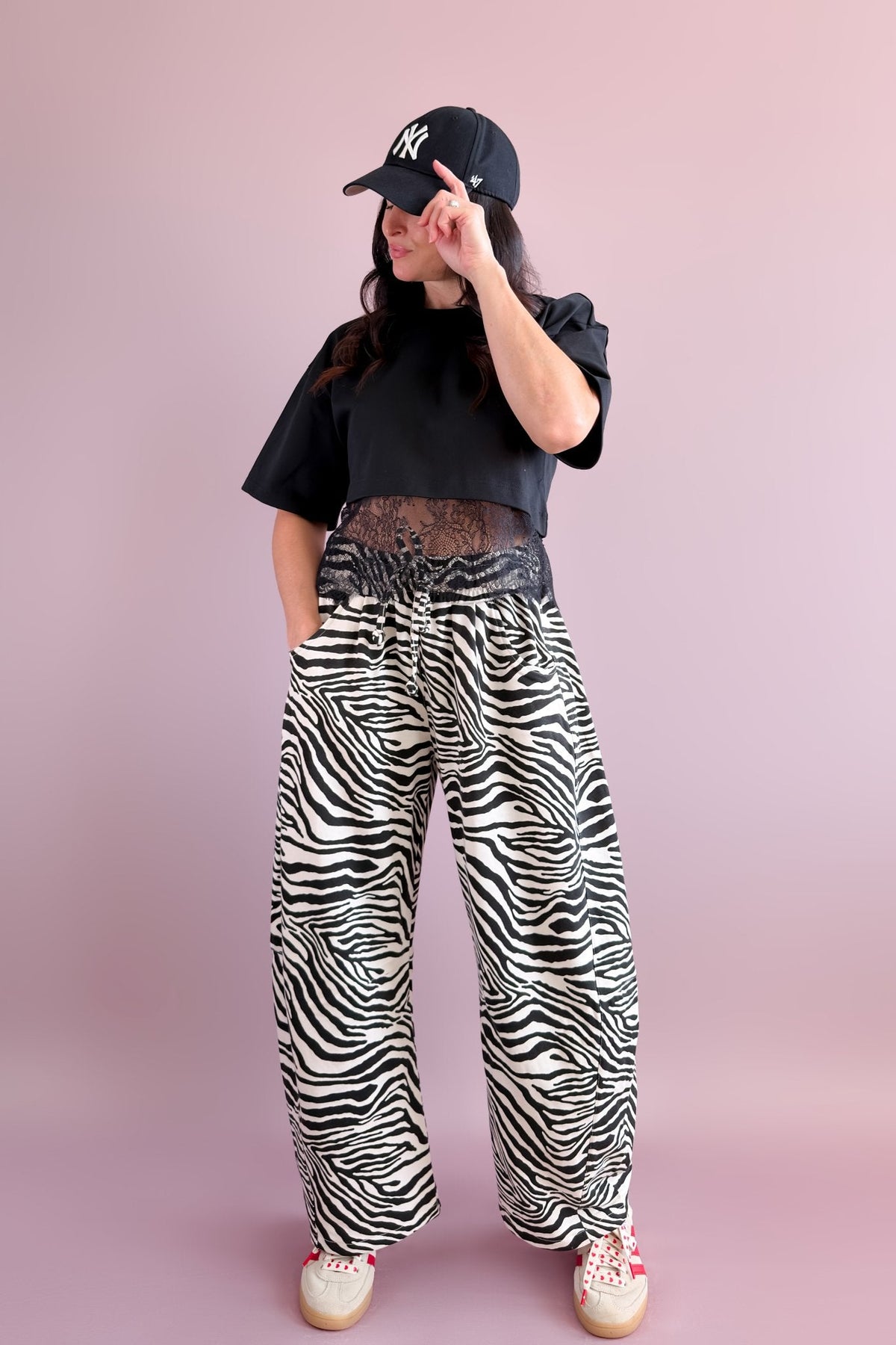 Back view of black and ivory zebra print barrel pants showing the relaxed fit and curved leg silhouette