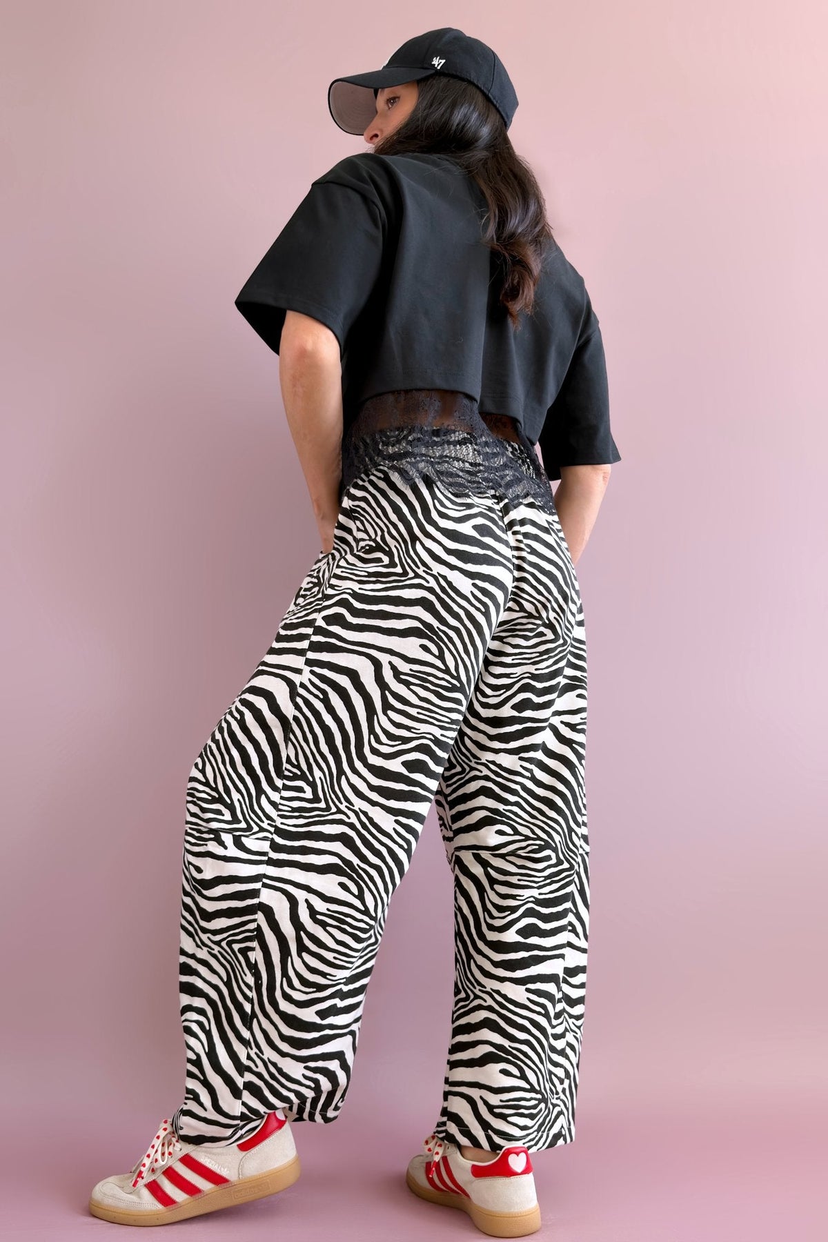Full-length view of black and ivory zebra print French terry barrel pants with a roomy fit and casual styling