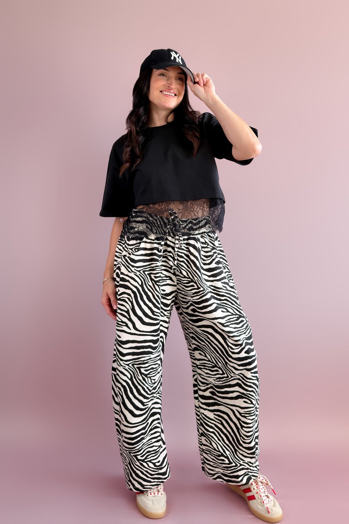 Close-up of black and ivory zebra print French terry pants showing the drawstring waistband and roomy barrel-leg shape